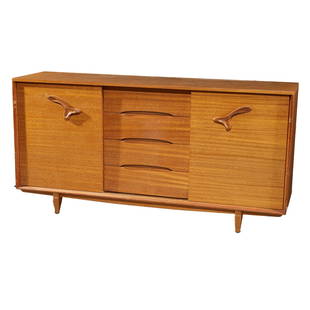 Paul Laszlo for Brown Saltman Sideboard: Paul Laszlo for Brown Saltman SideboardA pair of sliding doors with organic design handles opening to a fitted interior. 37in. (94cm) h. 74in. (188cm) l. 20in. (51cm) d.