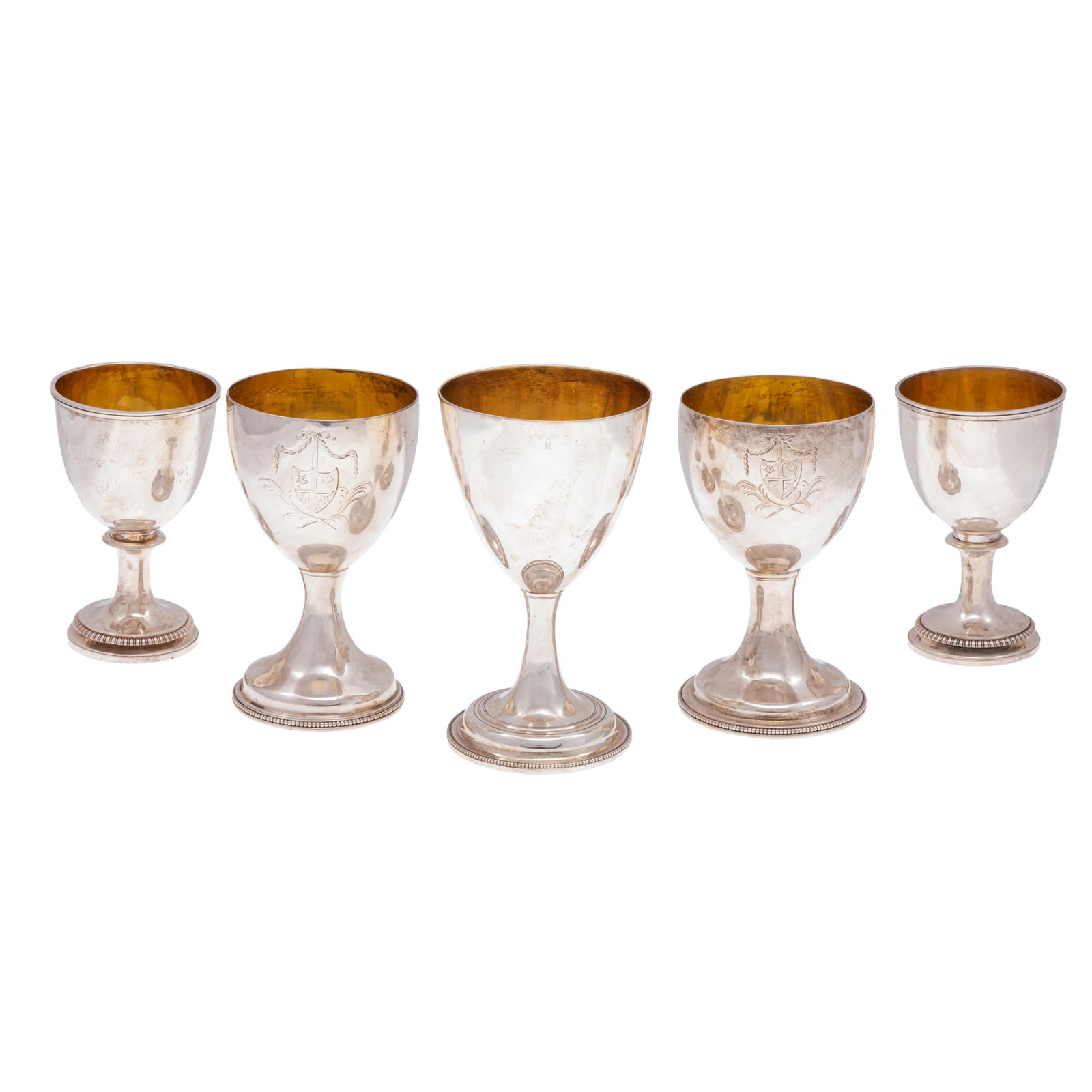 Collection of Georgian Sterling and Gilt Goblets: Five sterling and gilt goblets, comprising;one 6 1/4in goblet date for London 1788.two 5 3/4in monogrammed with quartered shield marked for London 1778Two 5in.marked for London 1812968.6 grams