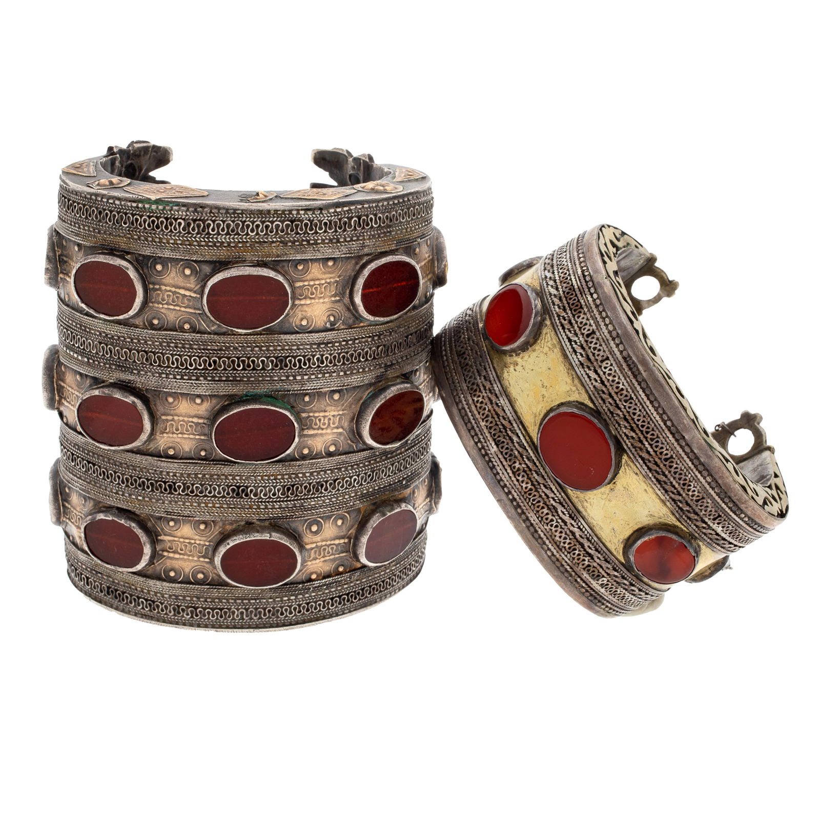 Pair of Turkomen Carnelian, Turquoise, Silver Cuff Bracelets: Pair of Turkomen Carnelian, Turquoise, Silver Cuff BraceletsTwo silver, silver gilt cuffs, the first featuring fifteen oval carnelian tablets set in three horizontal stations, all terminating to a cro