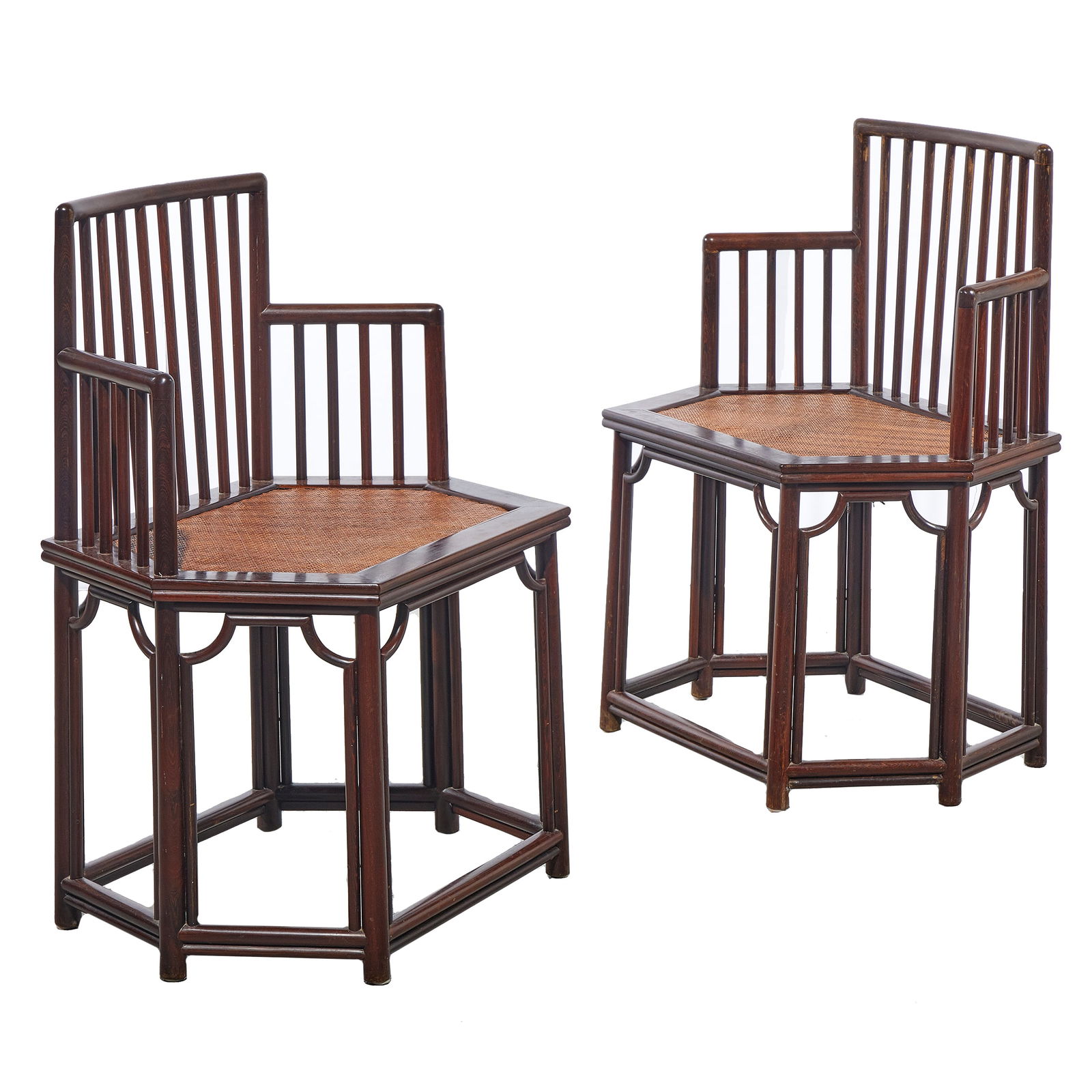 Pair Chinese Corner Chairs: Pair Chinese Corner ChairsEach of hardwood with octagonal woven seat and spindle back and sides.20th century. 35in.(89cm) h. 25in. (63cm) w. 18in.(46cm) d.From the estate of a San Francisco Collector