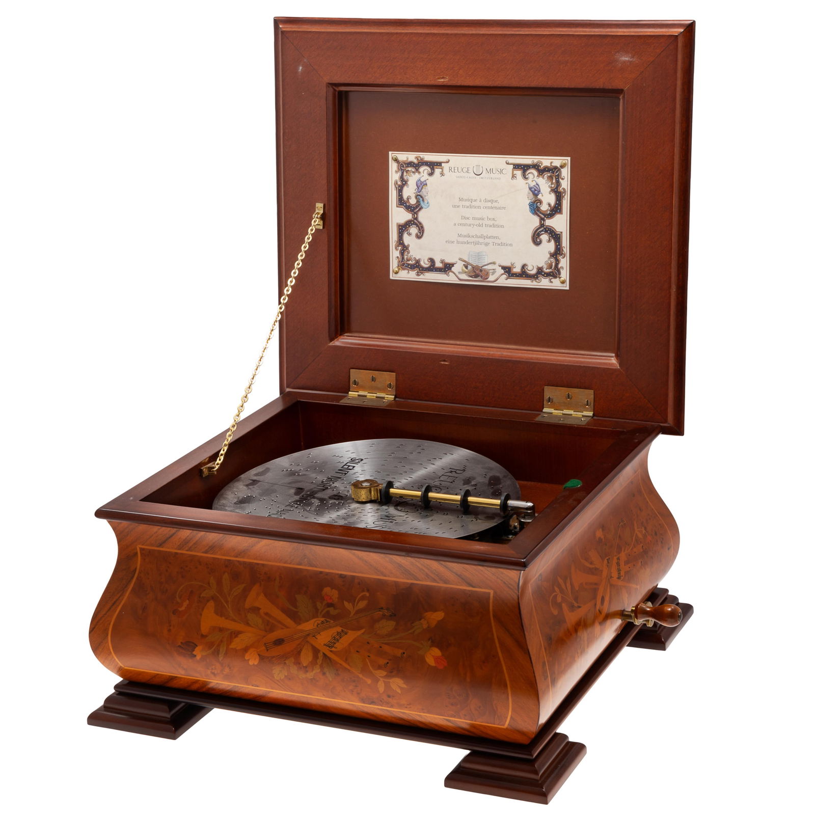 Reuge Disc Player, Switzerland: Reuge Disc Player, SwitzerlandThe player within an box inlaid with a musical trophy.10in (25cm) h. 17in (43cm) w 16in (41cm) d.
