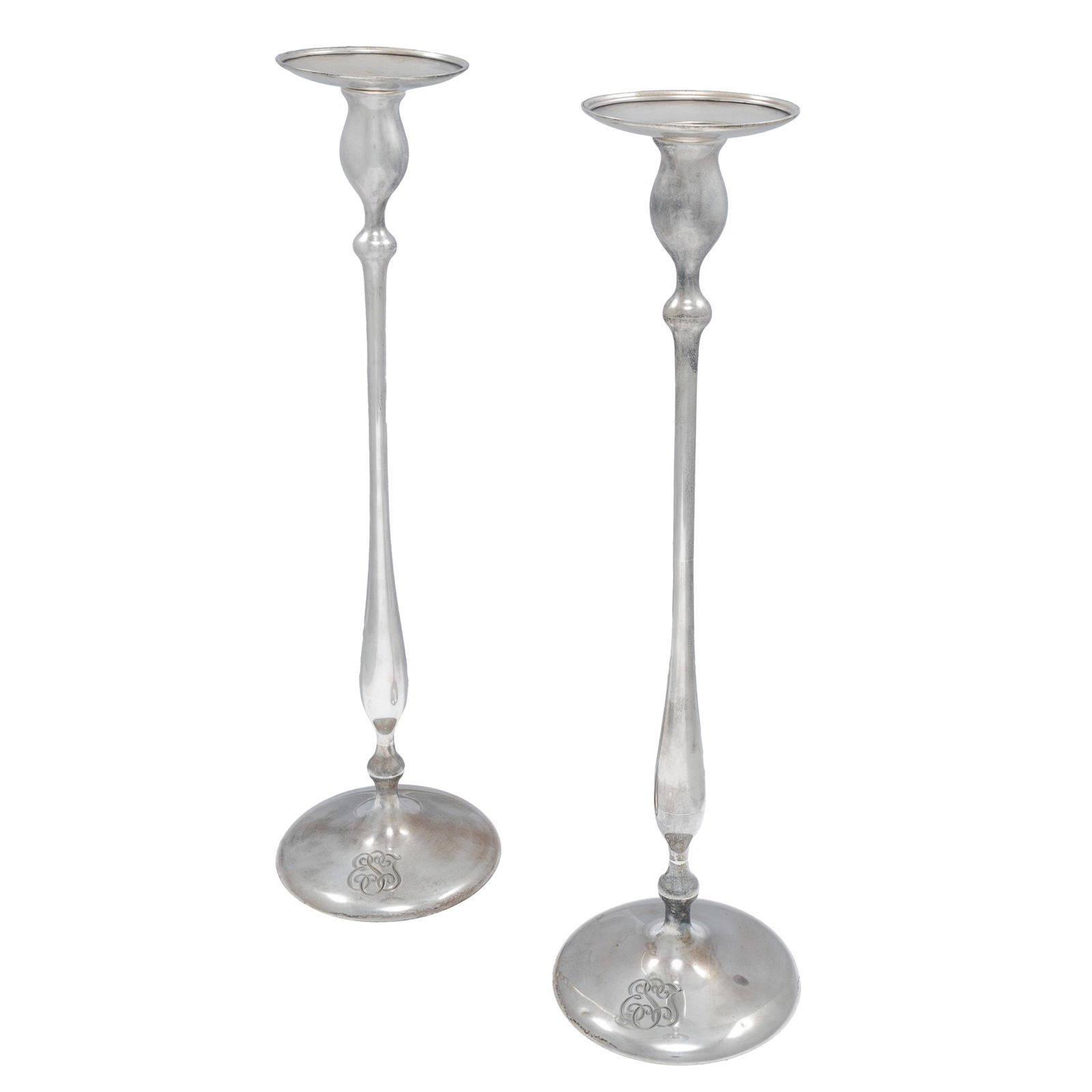 Pair Shreve & Co. Art Deco Sterling Candlesticks: Pair Shreve & Co. Art Deco Sterling CandlesticksEach with a dished bobeche raised on a tall vasiform and knopped standard.20in (51cm) h.1312.7 gramsMonogrammedCondition: minor dent at base, some tarni