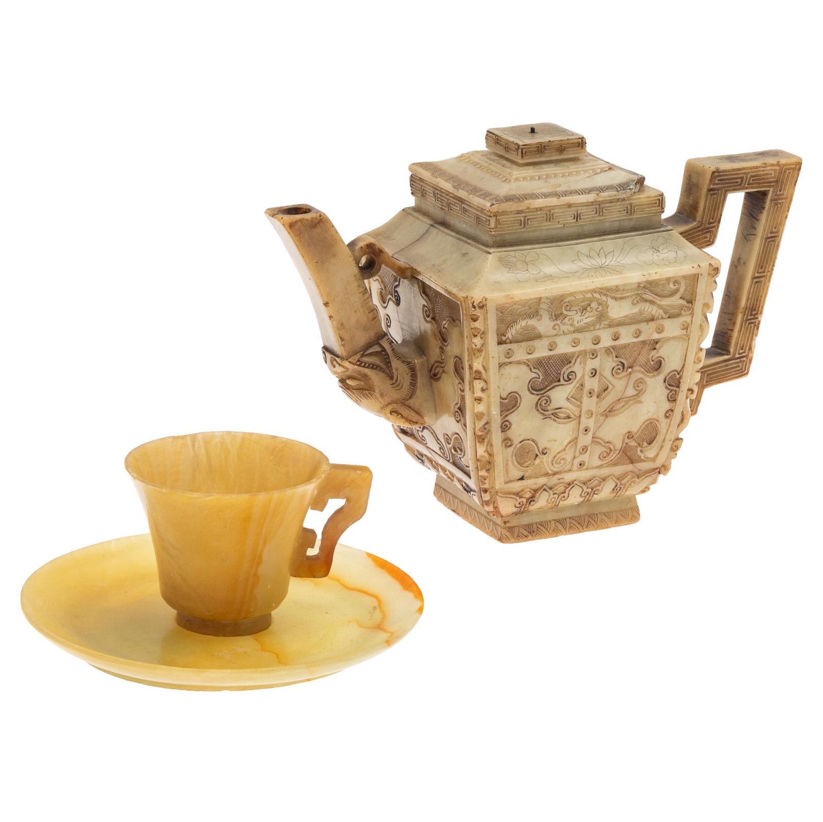 Kang Xi Style Hardstone Teapot, Cup and Saucer: Kang Xi Style Hardstone Teapot, Cup and Saucer Late 19th/early 20th century The teapot carved with incised dragons above geometric floral panels. Six character mark on base. 6 1/2in (16cm) h Together 