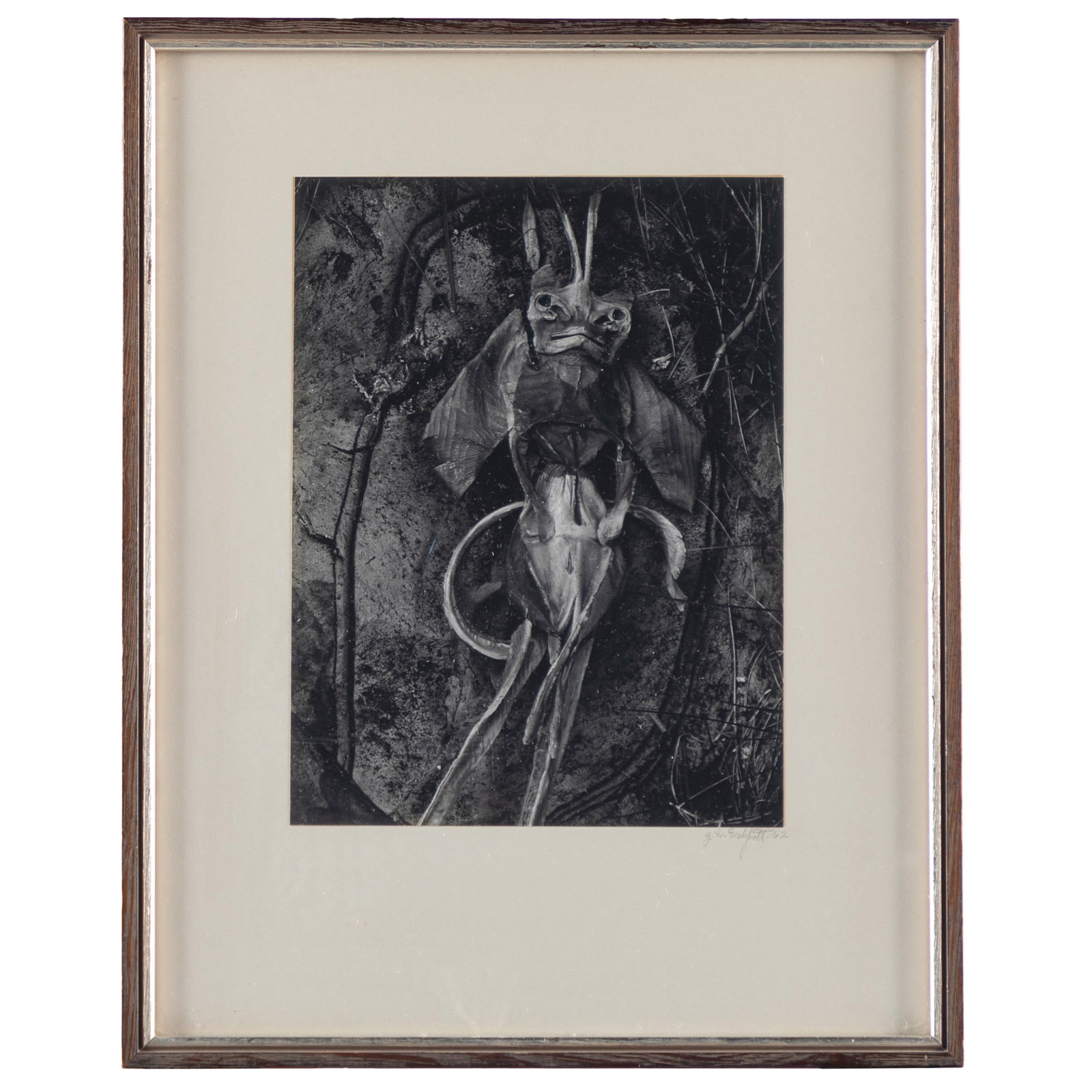 Jack Welpott (American, 1923-2007).: Jack Welpott (American, 1923-2007).Voodoo Doll, 1962.Gelatin silver print, signed and dated in pencil on the mount, framed.9 1/2 x 7 1/2in. (24 x 19 cm/image).Internationally known photographer and ed