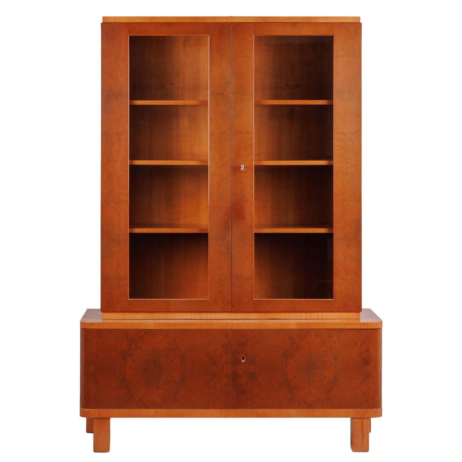 Art Deco Cabinet. Possibly English: Art Deco Cabinet. Possibly EnglishThe case of highly figured wood contrasting with lighter shelves and mother of pearl escutcheons within glazed doors raised on square block feet.66in (168cm) h. 46in
