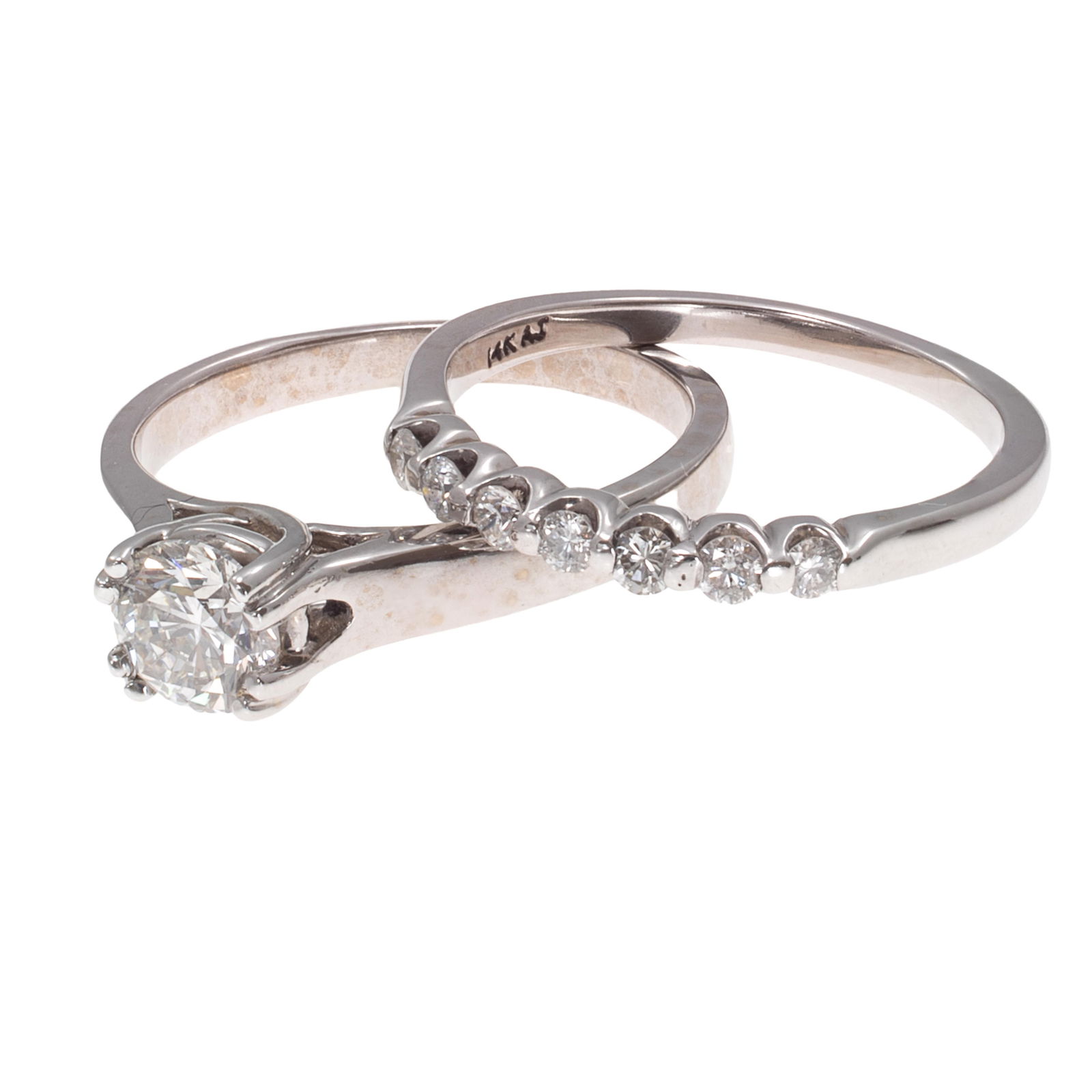 Diamond, 14k White Gold Engagement Set: Diamond, 14k White Gold Engagement SetIncluding a ring featuring a round brilliant-cut diamond weighing approximately 0.70 ct., set in a 14k white gold mounting, size 6 3/4; together with an anniversa