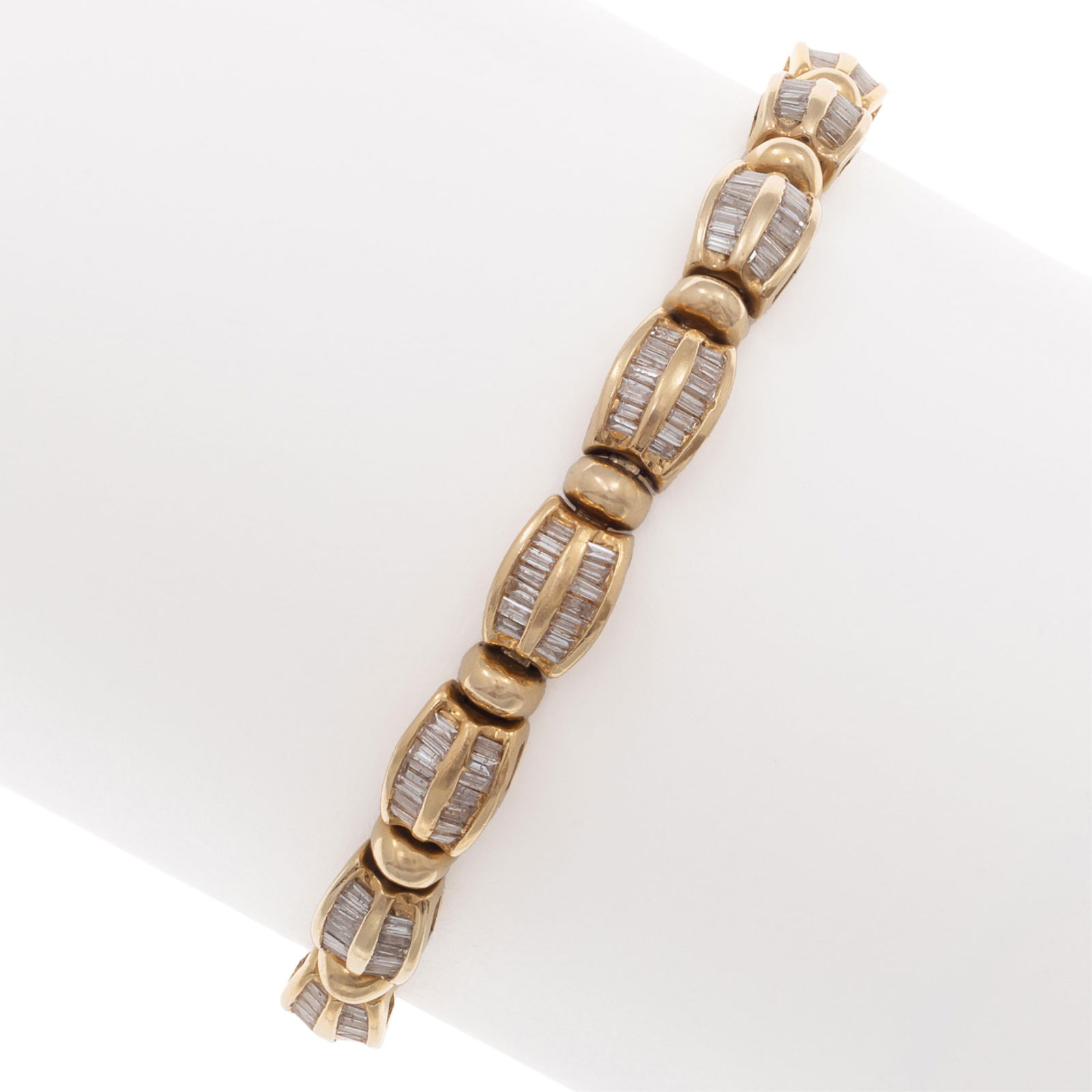 Diamond, 14k Yellow Gold Bracelet: Diamond, 14k Yellow Gold BraceletFeaturing two hundred twenty-two baguette-cut diamonds weighing a total of approximately 3.35 cttw., set in articulated, 14k yellow gold links completed by a push-butt