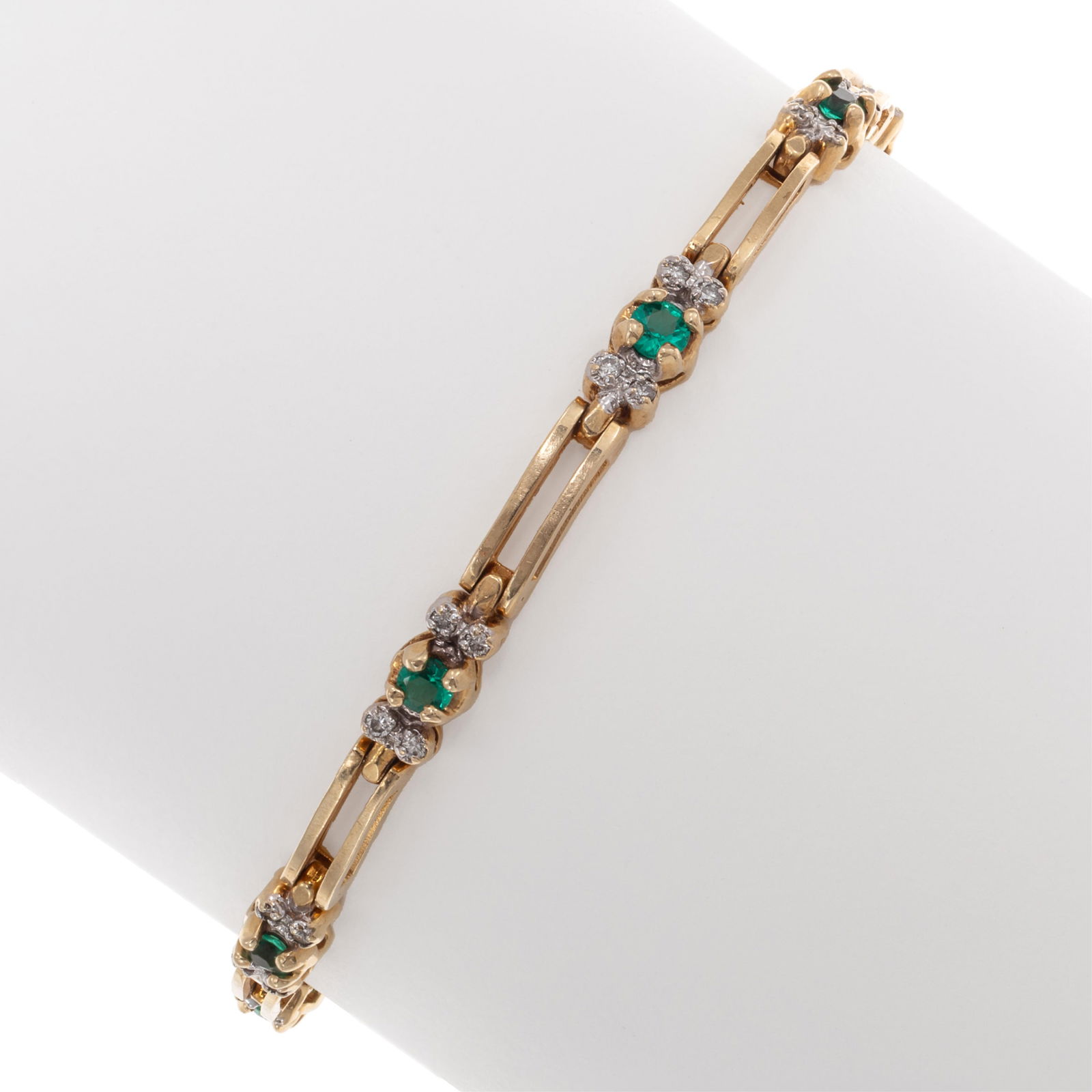 Diamond, Synthetic Emerald, 14k Yellow Gold Bracelet: Diamond, Synthetic Emerald, 14k Yellow Gold Bracelet Featuring nine round-cut synthetic emeralds, each measuring approximately 2.88 mm, accented by thirty-six round brilliant-cut diamonds weighing a