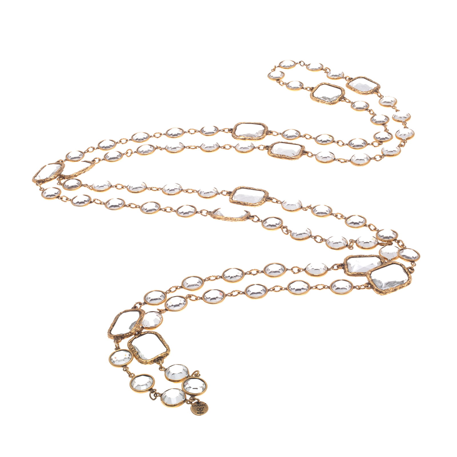 Chanel Glass, Chicklet, Necklace: Chanel Glass, Chicklet, NecklaceRectangular and round colorless glass set in gold-tone metal forming a 64 inch necklace. Gold-tone hangtag marked ,Chanel, crossed c logo, 1981.Gross weight: 124.7 gram