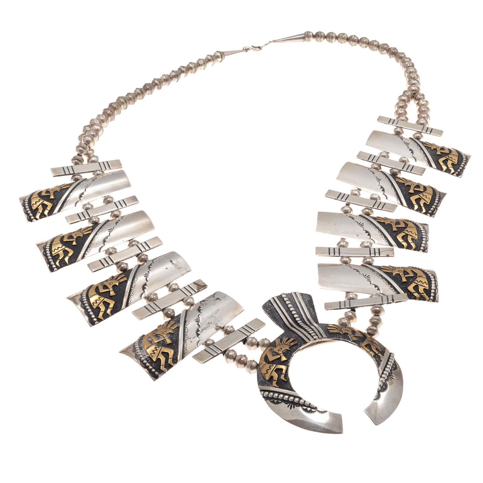 Navajo Silver, Brass Squash Blossom Necklace, Thomas Singer: Navajo Silver, Brass Squash Blossom Necklace, Thomas SingerDesigned with an overlaid brass 'Kokopelli' motif, featuring one sterling silver naja measuring approximately 3.40 x 2.45 inches inches, high