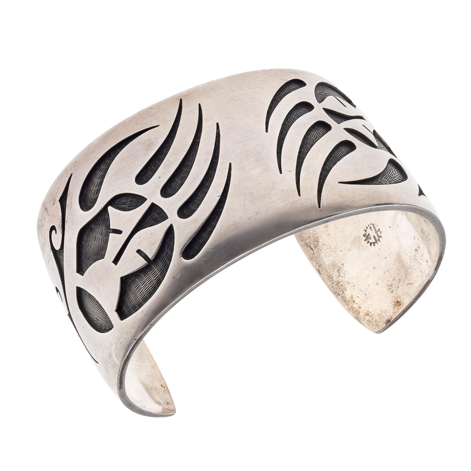 Hopi Sterling Silver Cuff Bracelet, Loren Phillips: Hopi Sterling Silver Cuff Bracelet, Loren PhillipsOverlay depicting two bear claws set in a sterling silver cuff mounting measuring approximately 1.50 inches in width, inner circumference 7 1/4 inches