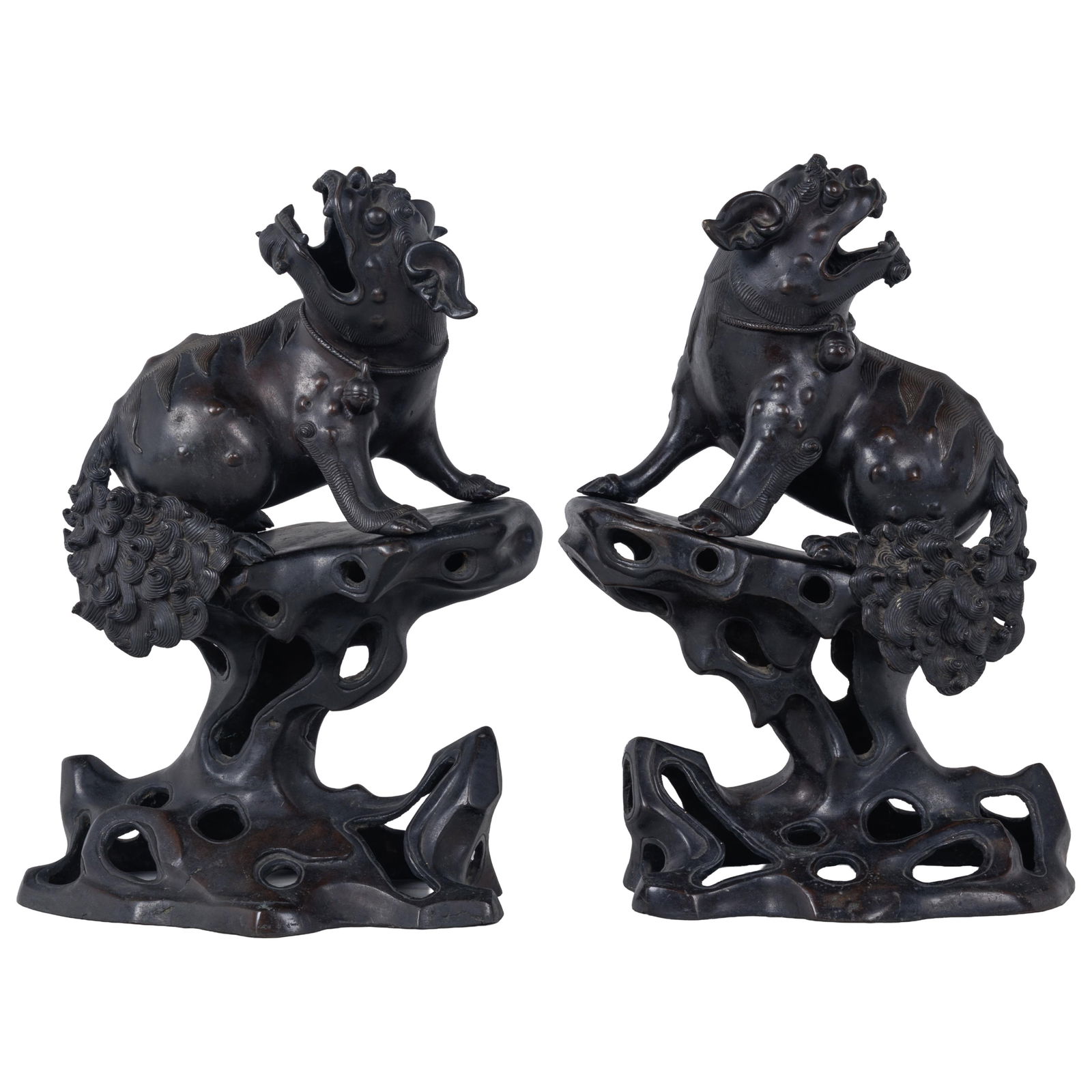 Pair of Bronze Thai Singha: Pair of Bronze Thai Singha A pair of guardian lions each sitting upright with spiked mane and fierce expression. 11 1/2in (29cm) h. Condition: One lion missing ear. Provenance: Tribhovandas Zaveri