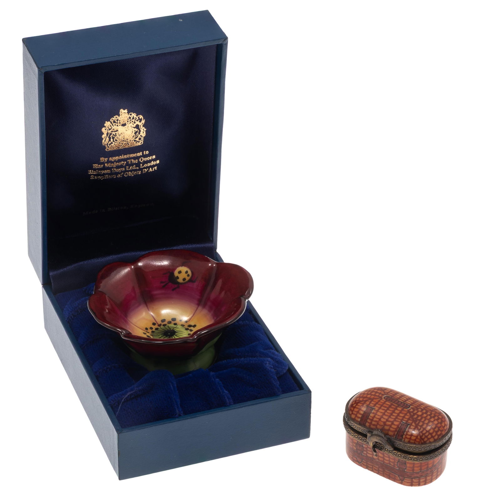 Two Limoges Porcelain Boxes: Two Limoges Porcelain Boxes One in the form of a wicker creel box 1 1/4 in x 1 1/2in (3cm. x 4cm) One 'Chamart' Red Poppy box. 2in. x 2 1/2in (5cm. x 6cm)