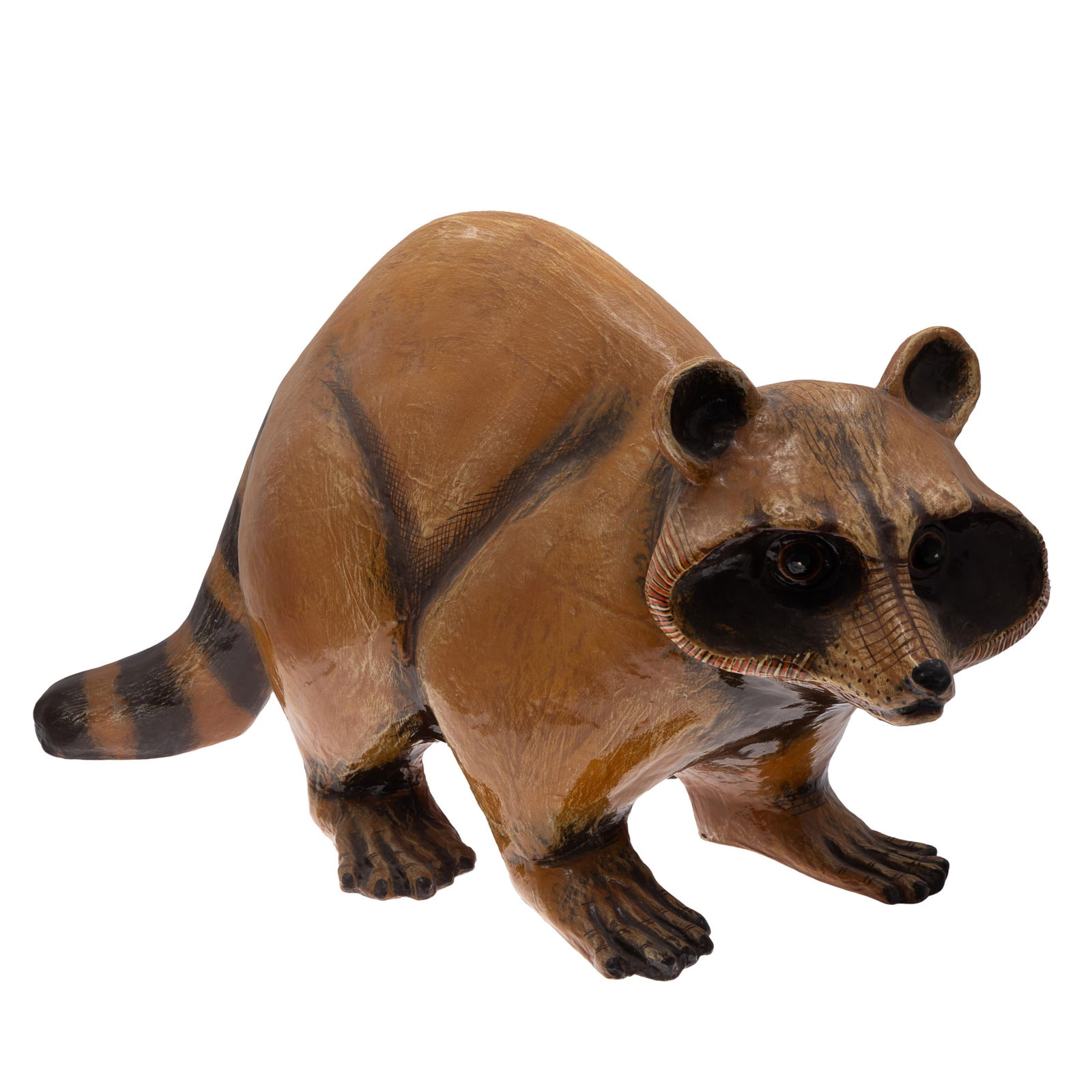 Sergio Bustamante (Mexico, b. 1949) Sculpture: Sergio Bustamante ( Mexico, b. 1949) SculptureOf Papier mache, the figure of a full grown racoon, crouching forward on it's nimble paws with alert expression. defined by its dark colored eye mask.18in