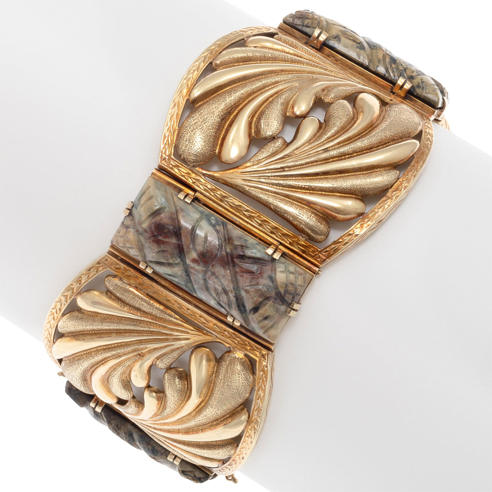 Hardstone, 14k Yellow Gold Bracelet: Hardstone, 14k Yellow Gold BraceletDesigned as repousse leaves interspaced by carved hardstone plaques, set in a 14k yellow gold mounting measuring approximately 1.50 inches in width, completed by a t