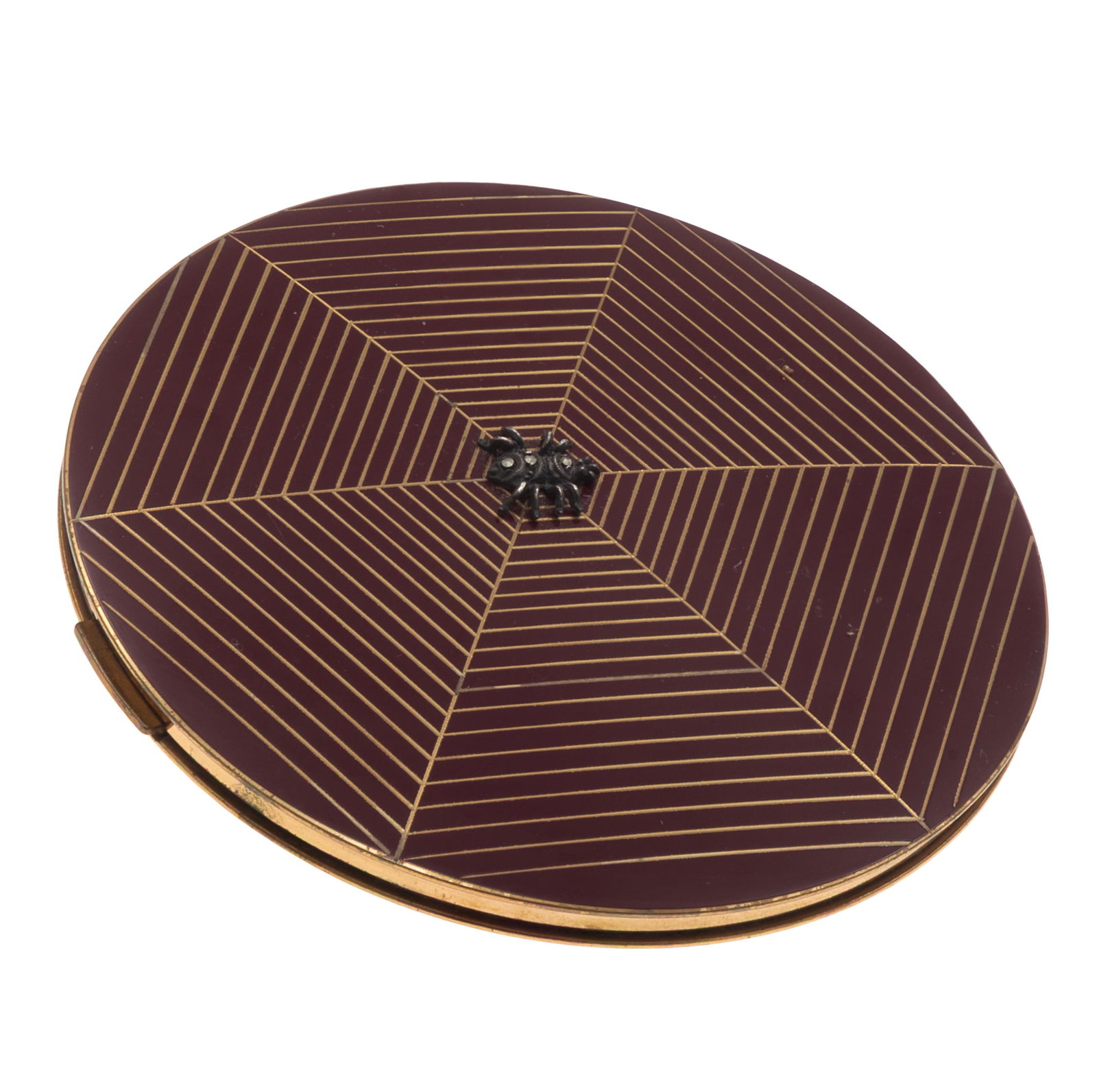 Art Deco Gilt and Lacquer Compact: Art Deco Gilt and Lacquer CompactThe cover of concentric threads divided by six rays creating the effect of a spider's web, at the center a 'jeweled' spider. The hinged cover opening to a mirror and p