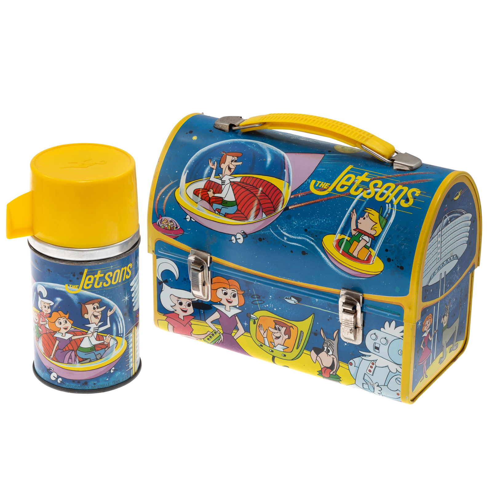 The Jetsons Tin Litho Dome Top Lunchbox, Vintage 1963: The Jetsons Tin Litho Dome Top Lunchbox Vintage 1963 Blue and Yellow with scenes from the animated cartoon. 7in (18cm) h. 9in (22cm) l. 4in (10cm) w Including half pint Jetsons Thermos. Label under