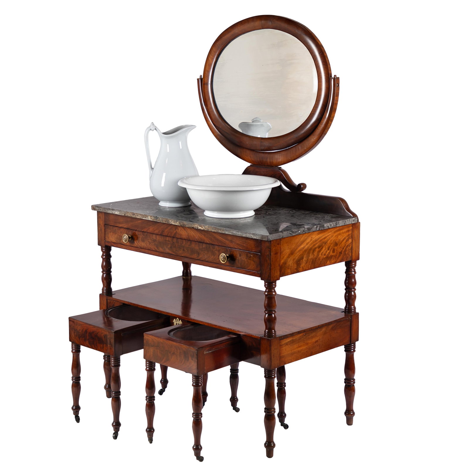 William IV Mahogany Dressing Table: William IV Mahogany Dressing Table An oval mirror surmounts a fossil marble top and a lower shelf on vasiform turned supports above an n arrangement of 'necessaire' slide out bidet and commode