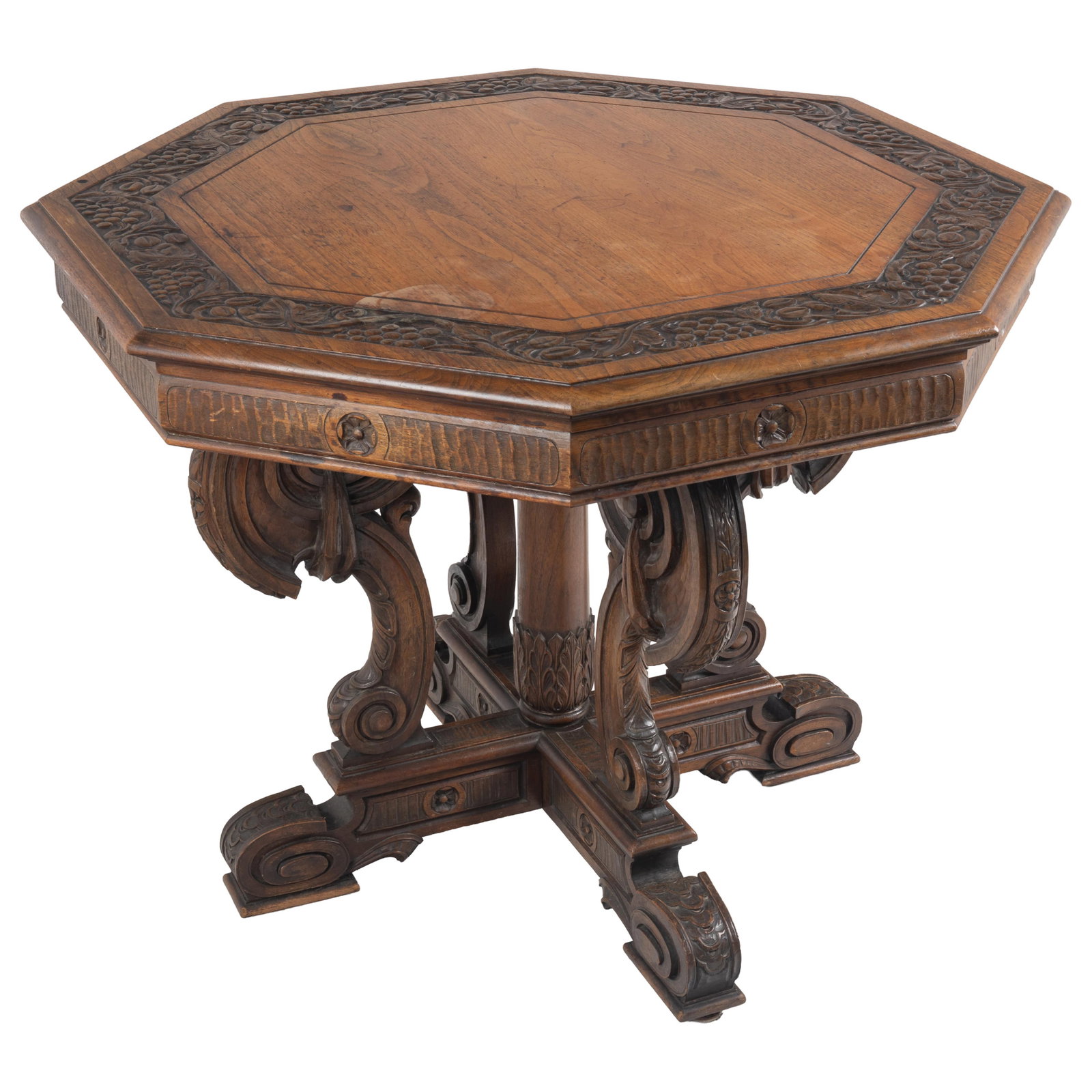 Renaissance Revival CenterTable: Renaissance Revival CenterTable The octagonal top relief carved with a band of grape vines raised on a quarto section support of draped scroll work. 30in (76cm) h. 38in (97cm) d.