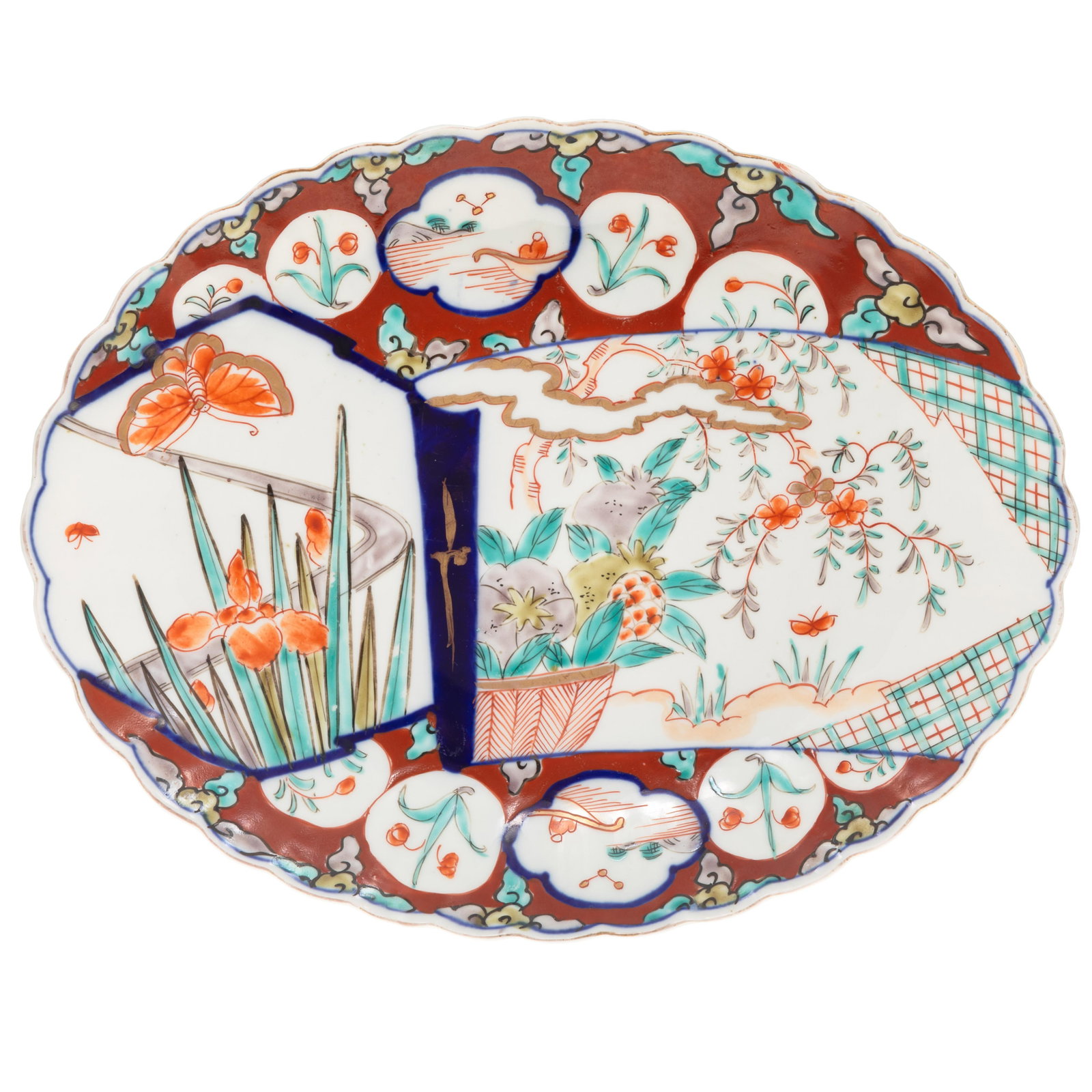 Imari Platter: Imari Platter Oval with scalloped edge, decorated with a reserve of iris in bloom and a basket of fruits on a checkered ground. 13 1/2in (34cm ) l. 11in (28cm) h