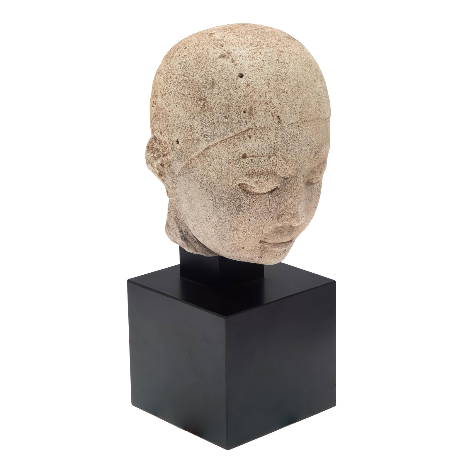 Burmese Carved Tufa Head Of a Monk: Burmese Carved Tufa Head Of a Monk Pyu, Eighth Ninth Centuries A.D. The full face with heavy-lidded down-cast eyes under arched brows and tight cap coif. 8 1/2in (22cm) On pedestal 13in (33cm) h 
