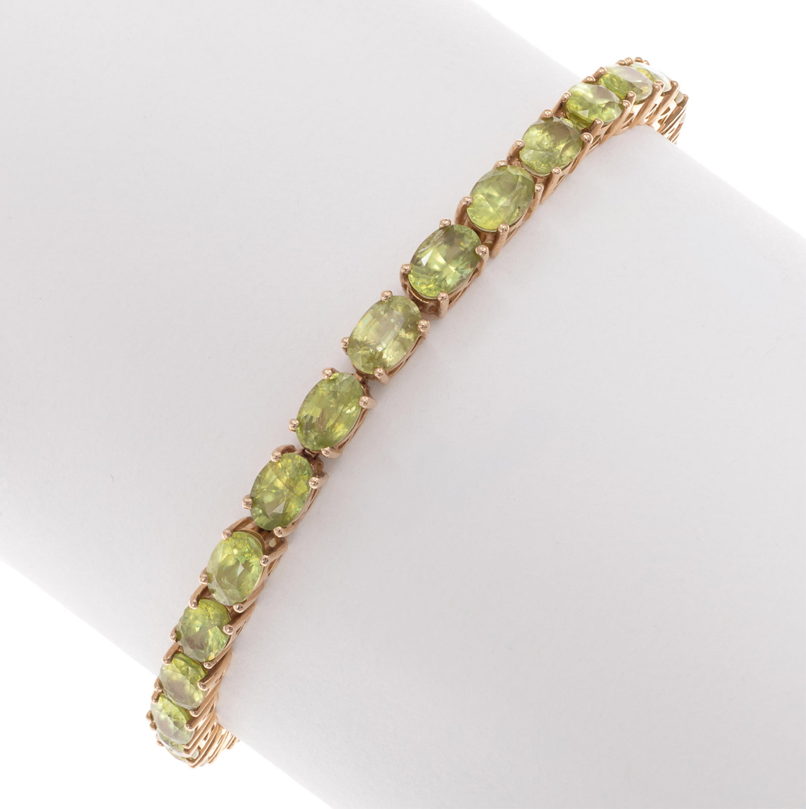 Sphene, 14k Yellow Gold Bracelet: Sphene, 14k Yellow Gold Bracelet Featuring thirty-one oval-cut sphene, each weighing approximately 0.55 ct., set in an articulated, 14k yellow gold mounting completed by a tongue-and-groove clasp with