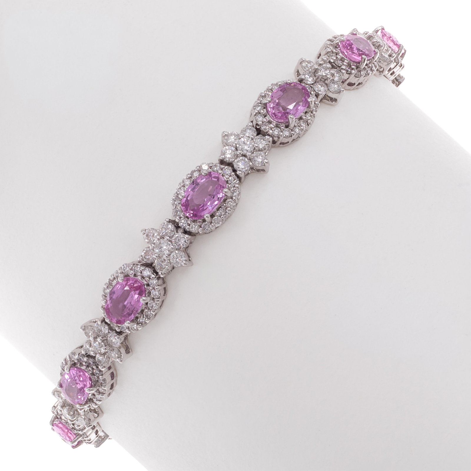 Pink Sapphire, Diamond, 14k White Gold Bracelet: Pink Sapphire, Diamond, 14k White Gold Bracelet Featuring thirteen oval-cut pink sapphires weighing a total of approximately 5.85 cttw., accented by round brilliant-cut diamonds weighing a total of