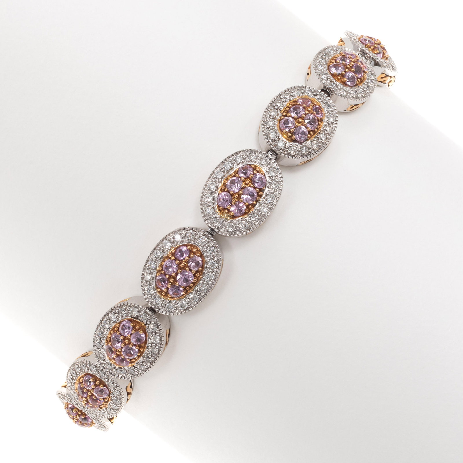 Pink Sapphire, Diamond, 18k White and Yellow Gold Bracelet: Pink Sapphire, Diamond, 18k White and Yellow Gold Bracelet Featuring ninety-six round pink sapphires weighing a total of approximately 4.80 cttw., accented by two hundred fifty-six round
