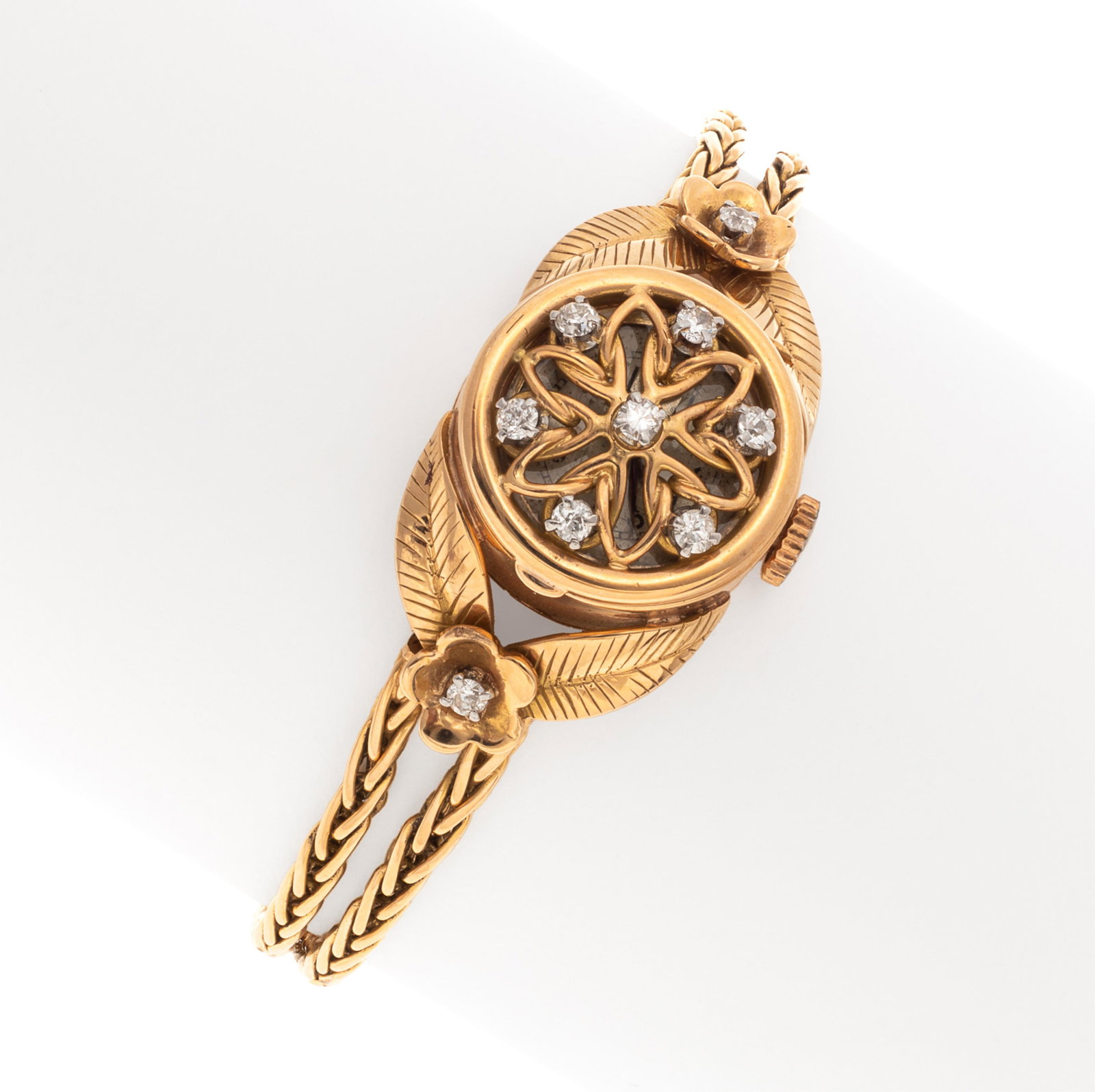 Diamond, 18k Hidden Watch Bracelet: Diamond, 18k Hidden Watch Bracelet Featuring nine round brilliant-cut diamonds weighing a total of approximately 0.36 cttw., set in an 18k yellow gold foliate motif mounting joined to wheat link chain