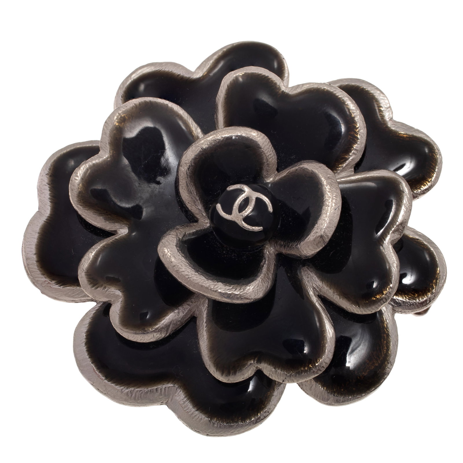 Chanel Enamel Camelia Pin: Chanel Enamel Camelia Pin Designed as a camelia flower centering the crossed 'C' logo, set in a palladium-plated, white metal pin mounting highlighted by black enamel, measuring approximately 1.95 inc
