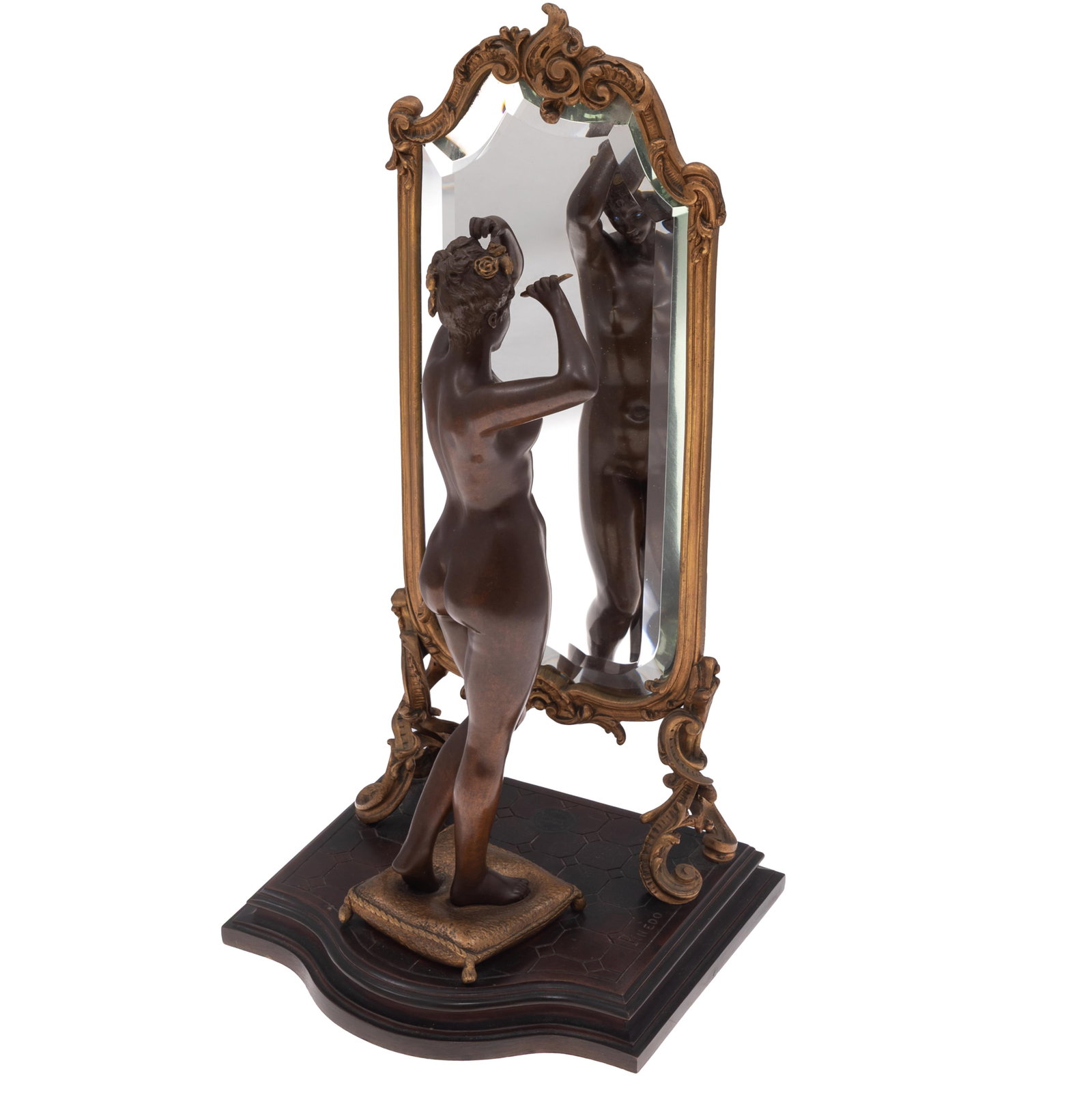 Emile Pinedo (French, 1840-1916)., Bronze: Emile Pinedo (French, 1840-1916). Bronze Depicting a nude woman arranging her hair in front of a mirror 24in (36cm) h. 7in (18cm) w. 5in (13cm) d. Inscribed on base: Pinedo Bearing plaque: Exposition 