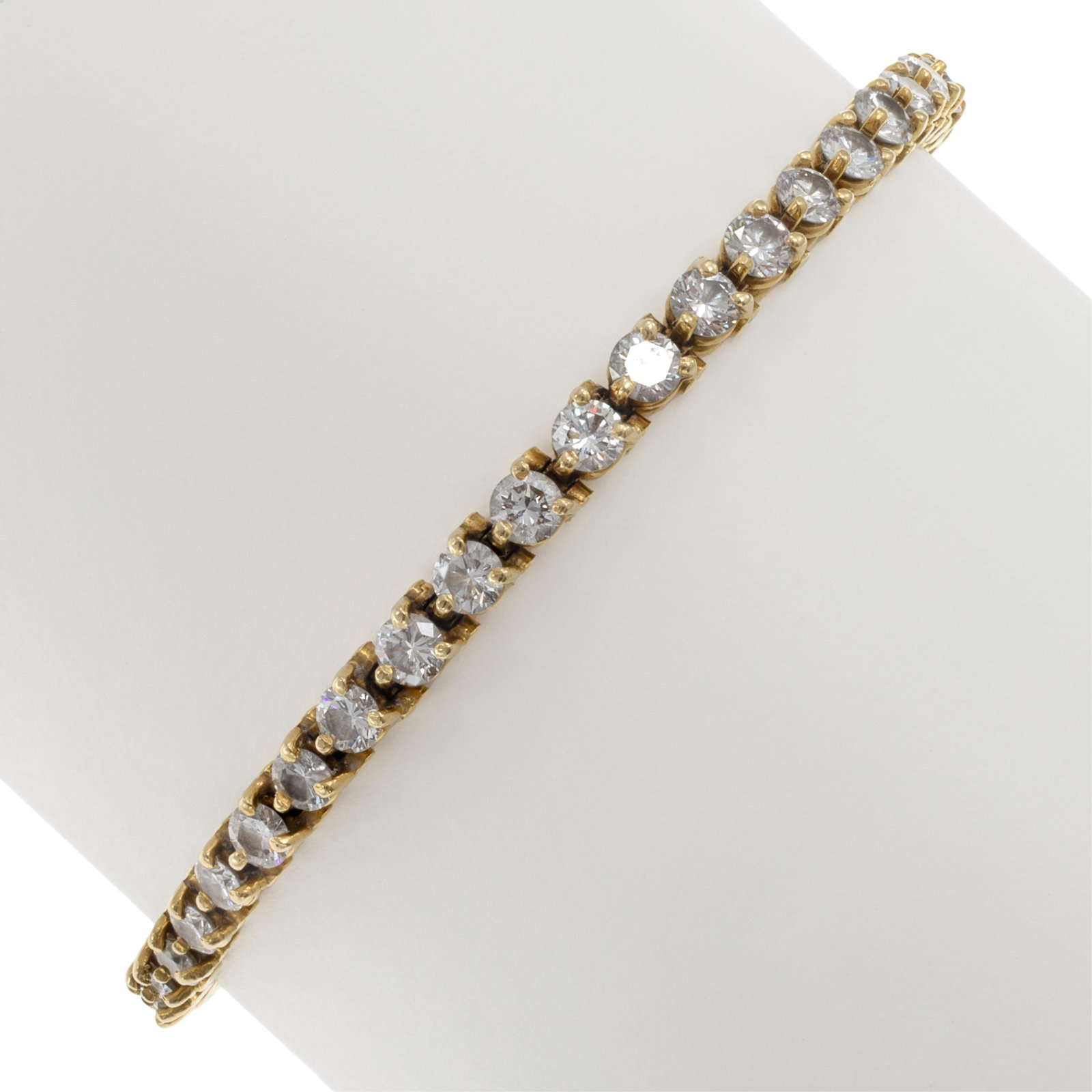 Diamond, 18k Yellow Gold Line Bracelet: Diamond, 18k Yellow Gold Line Bracelet Featuring forty-four round brilliant-cut diamonds weighing a total of approximately 5.70 cttw., set in an articulated, 18k yellow gold mounting completed by a