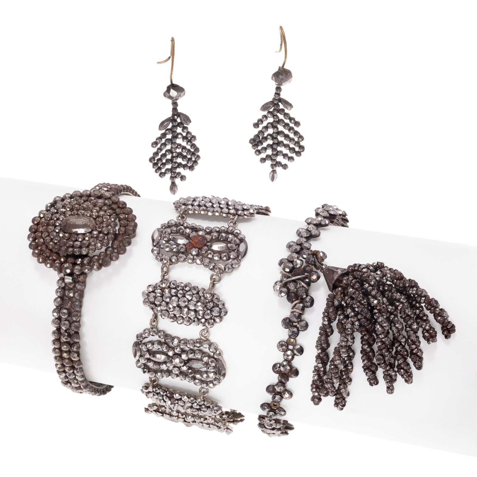 Collection of Victorian Cut Steel Jewelry: Collection of Victorian Cut Steel Jewelry Including one articulated links bracelet, 7 inches; one hinged bangle bracelet with circular hidden box clasp; one bangle bracelet with tassel, inner circumfe