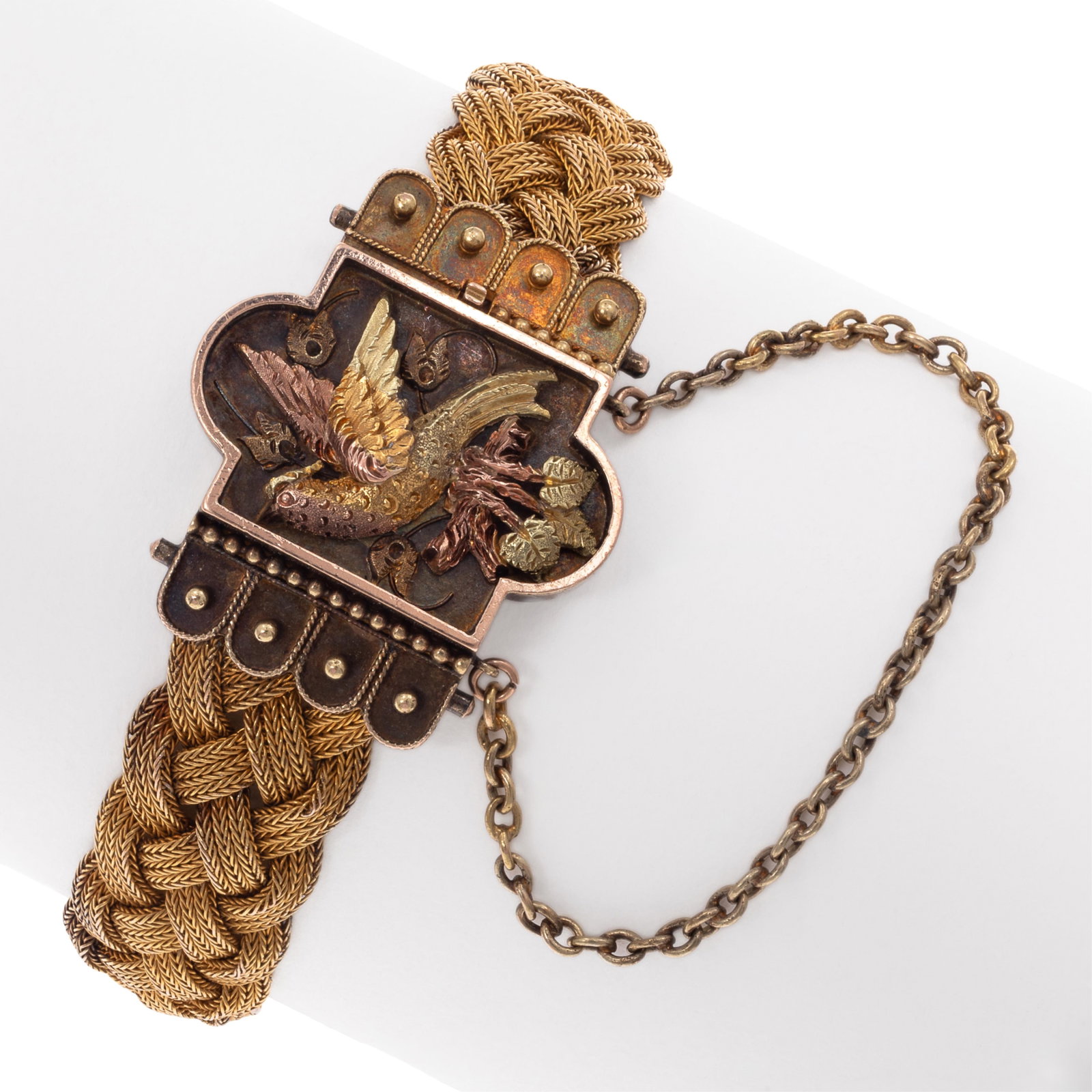 Victorian Yellow Gold Bracelet: Victorian Yellow Gold Bracelet The tested-to 14k yellow gold finely braided strands joined to a tongue-and-groove clasp centering a multi-colored gold bird perched on a leafy branch, forming a 6 inch