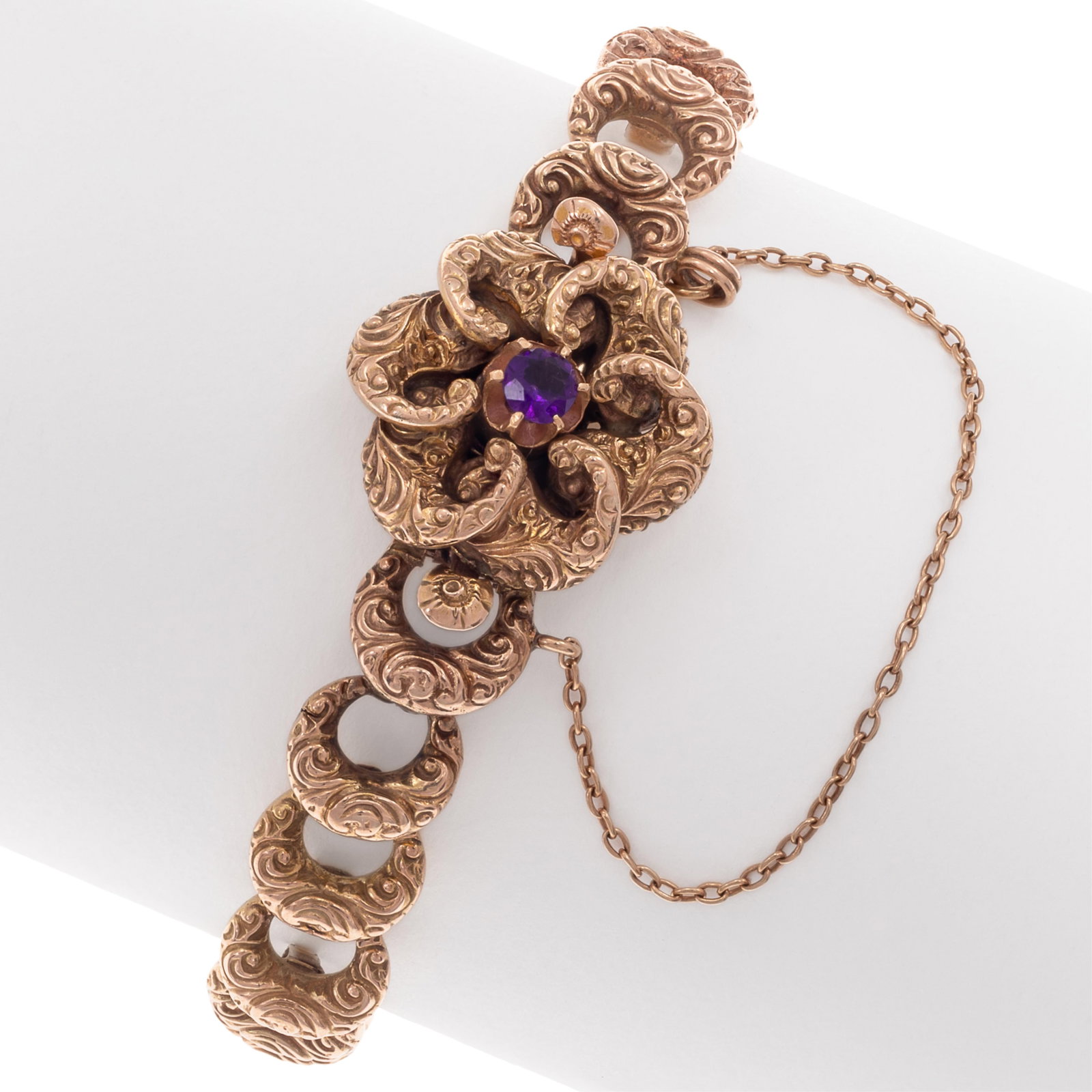 Victorian Amethyst, 14k Rose Gold Bracelet: Victorian Amethyst, 14k Rose Gold Bracelet The 14k rose gold repousse links, completed by an amethyst, flower-form hidden push-button clasp with safety chain, forming a 6 1/2 inch bracelet. Gross