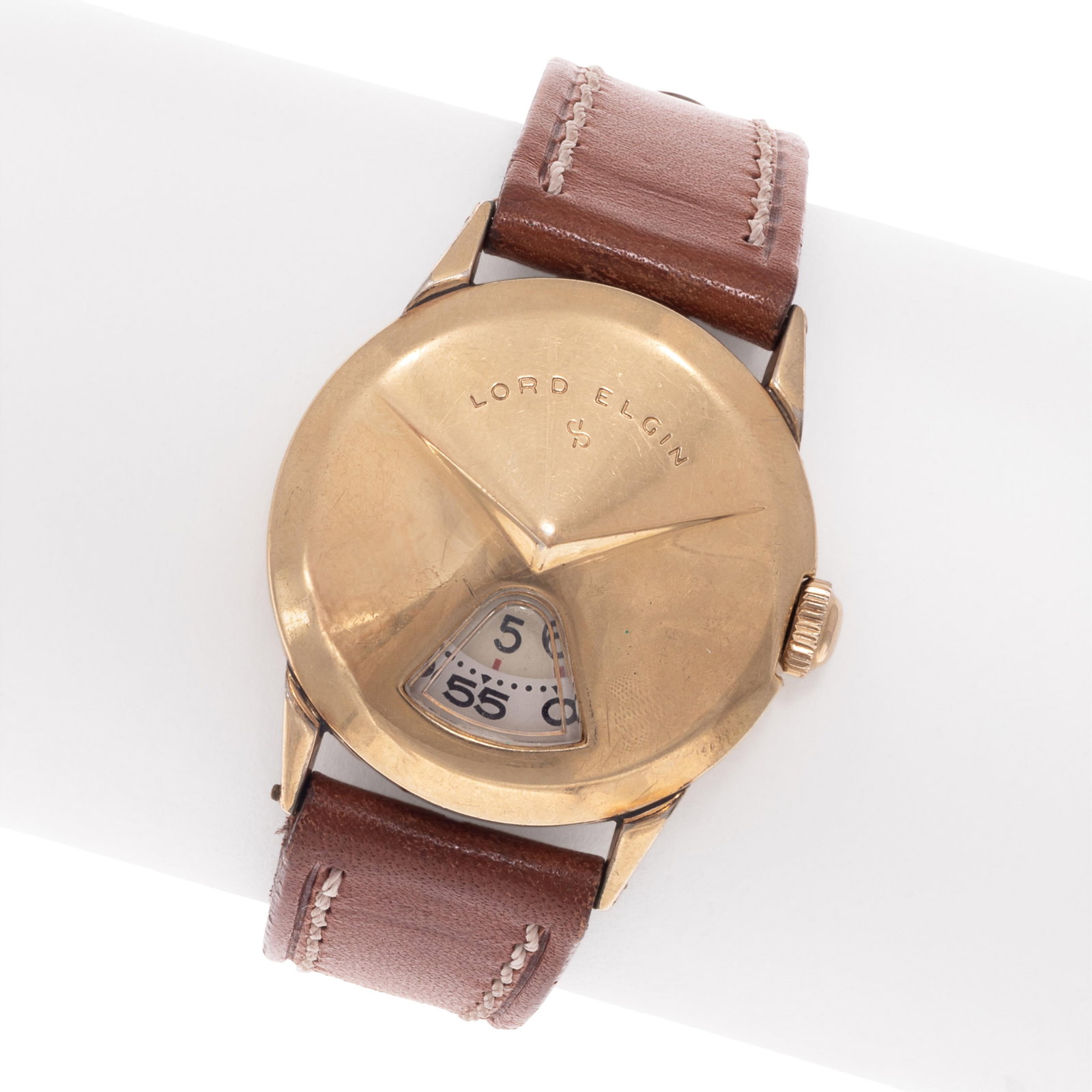 1950 Lord Elgin Direct Read Gold-Filled Wristwatch: 1950 Lord Elgin Direct Read Gold-Filled Wristwatch DIAL: Gold-filled dial guard with chevron aperture for minutes and hours at 6 o'clock. MOVEMENT: Mechanical, twenty-one (21) jewels, caliber 719,