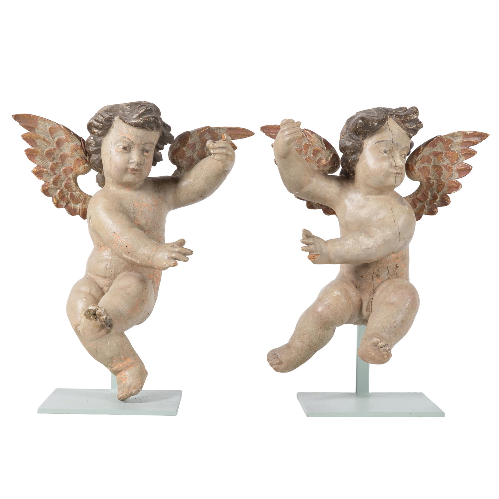 Pair of Renaissance Revival Painted Wood Putti: Pair of Renaissance Revival Painted Wood Putti Each winged figure depicted in a frolicking pose. 16in (41cm) h. 22in (56cm) w. Condition: Both missing finger tips.