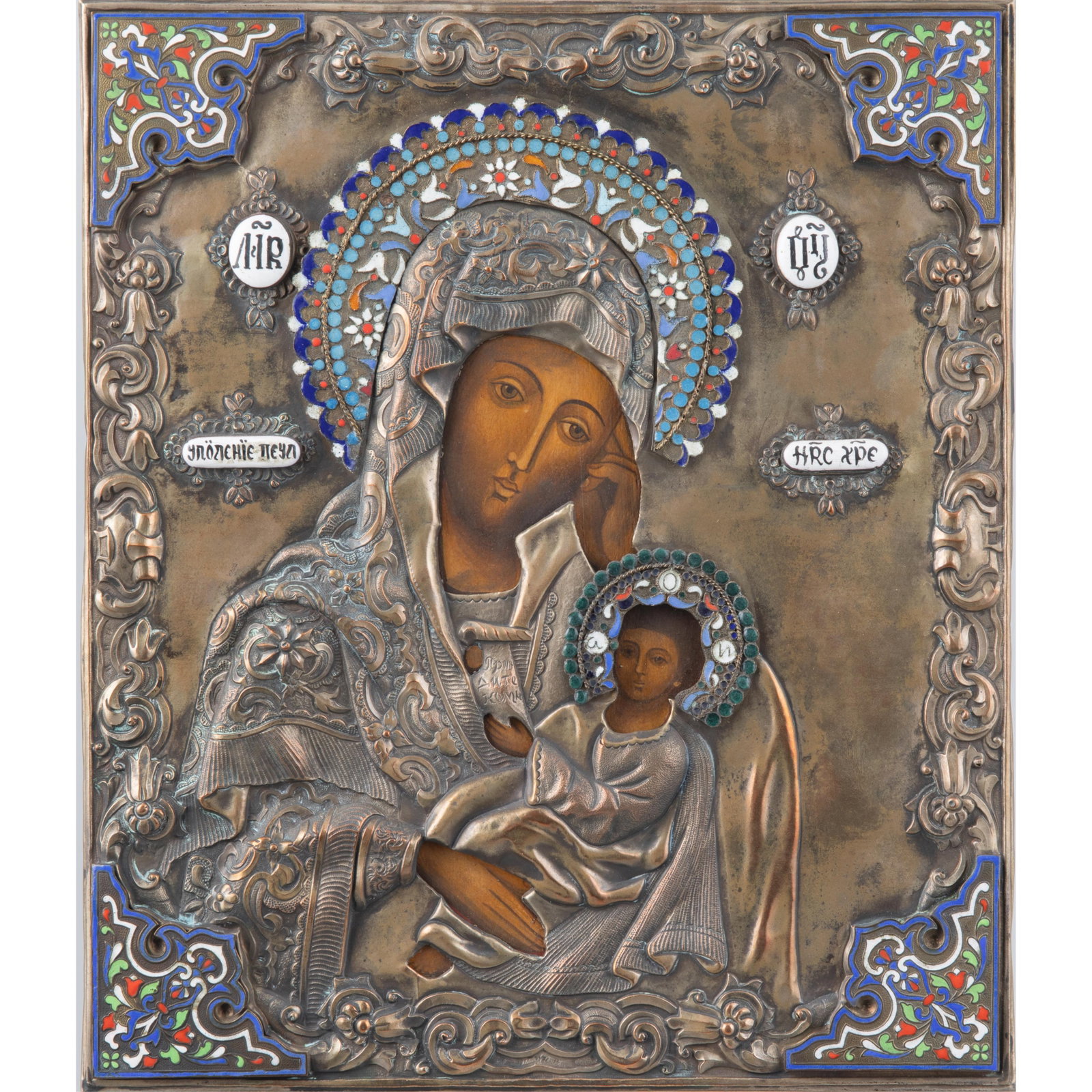 Eastern Orthodox Icon: Eastern Orthodox Icon The image of the Virgin and Christ child beneath a silvered and gilt oklad with cloisonne corners. 12in (31cm) h 10in (25cm) w