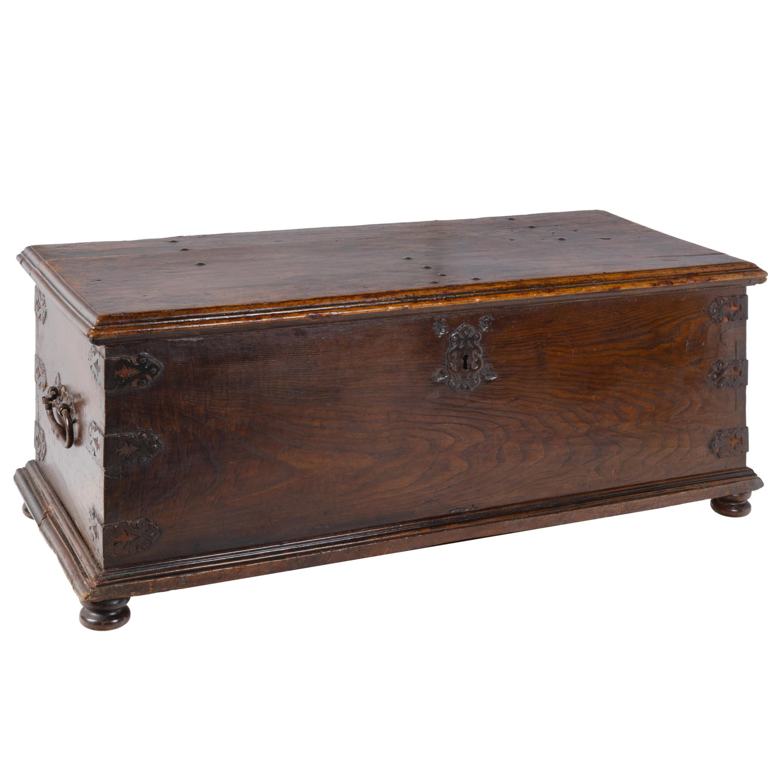 Spanish Baroque Walnut Trunk: Spanish Baroque Walnut Trunk Of large proportions, the trunk with stepped edge top over a case with decorative iron mounted corner braces ending in bun feet. 25in (64cm) h. 56in (143cm) l. 24in (61cm 