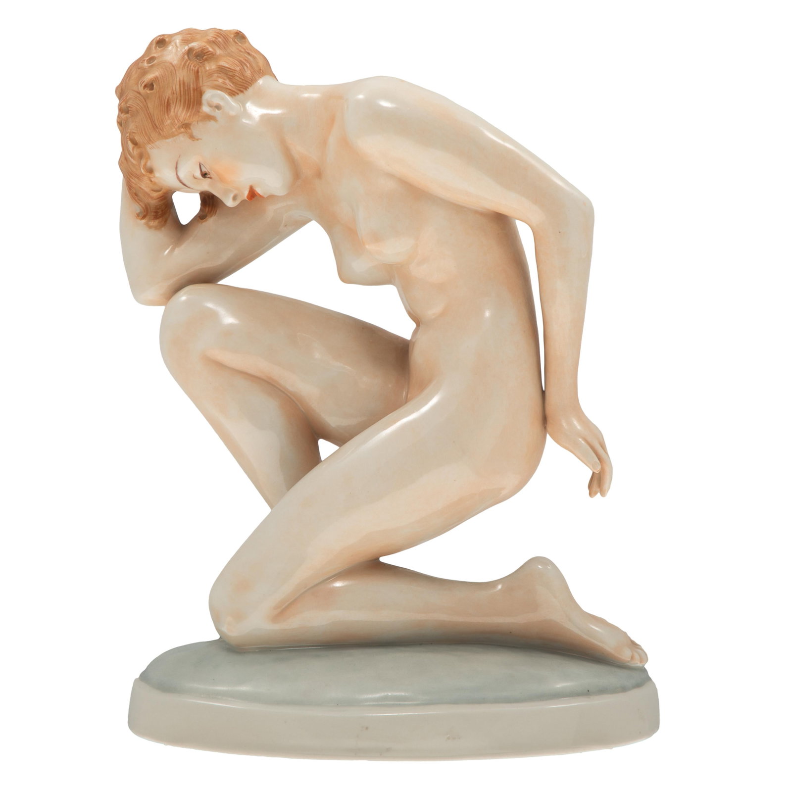 Royal Dux Porcelain Figure: Royal Dux Porcelain Figure The figure or a nude woman kneeling on an oval pedestal. 10 1/2in (27cm) h. Condition: Very good.