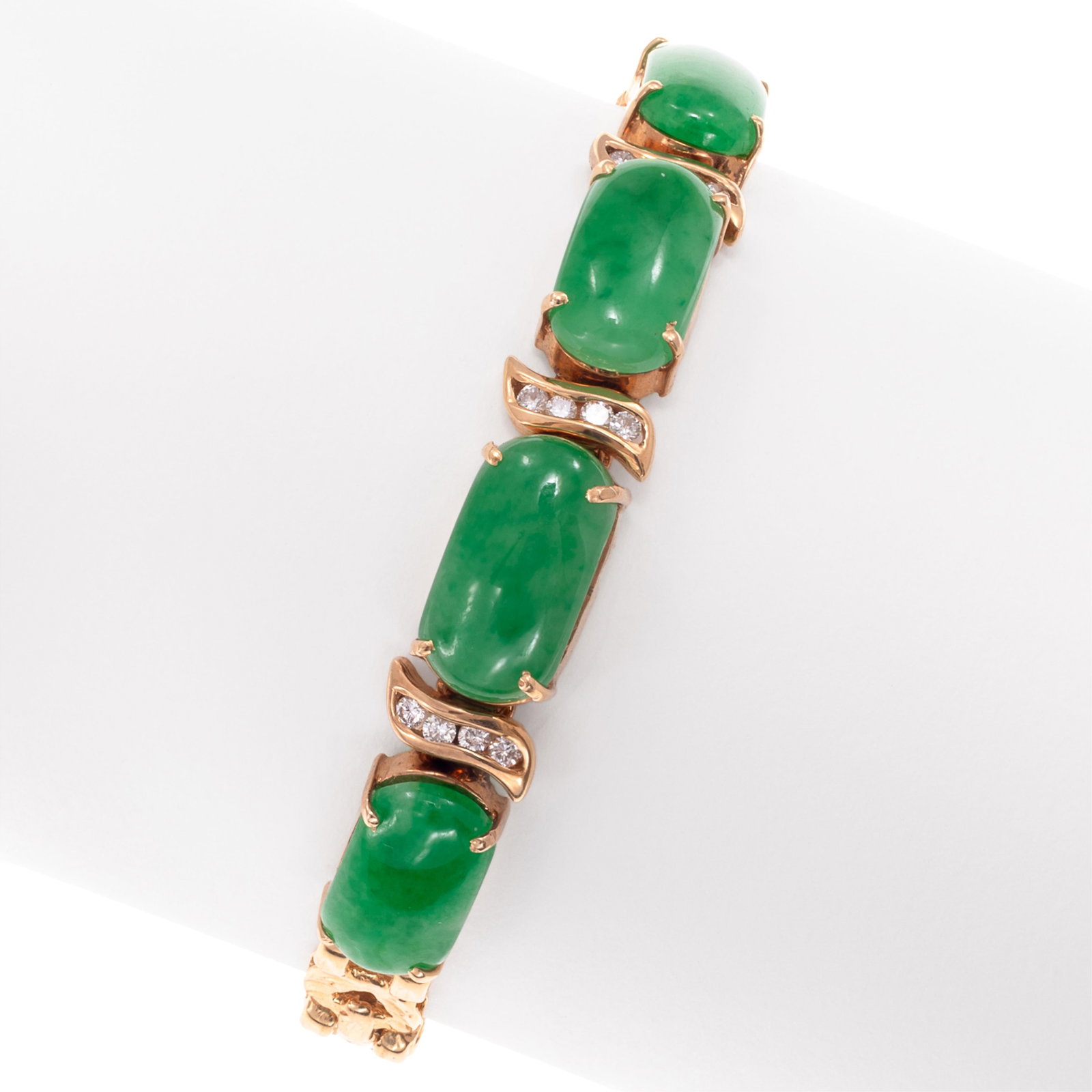 Jadeite Jade, Diamond, 14k Yellow Gold Bracelet: Jadeite Jade, Diamond, 14k Yellow Gold Bracelet Featuring four oval jadeite cabochons, each measuring approximately 13.0 x 7.0 mm, accented by twelve round brilliant-cut diamonds weighing a total of a