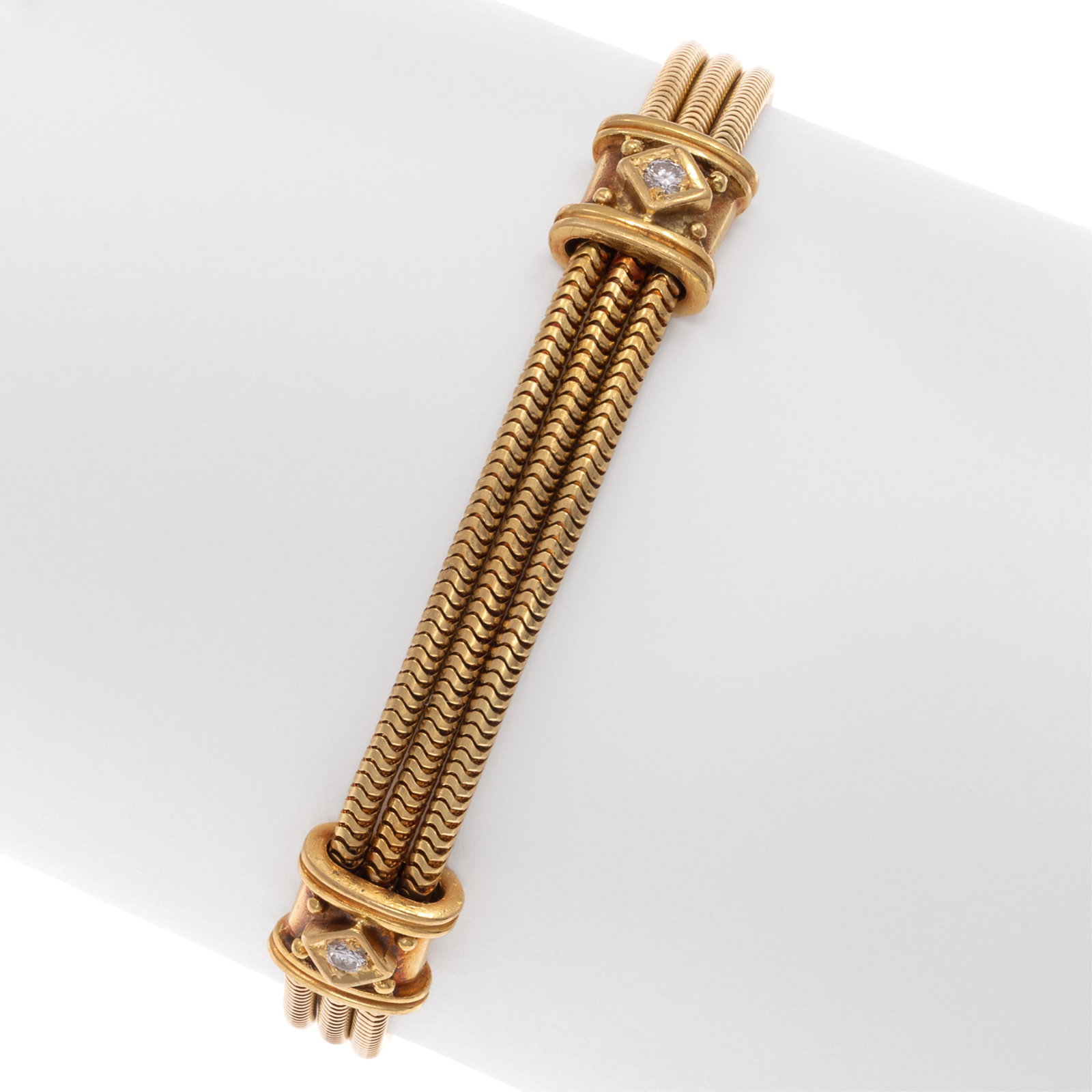 Diamond, 18k Yellow Gold Bracelet: Diamond, 18k Yellow Gold Bracelet Featuring three round brilliant-cut diamonds weighing a total of approximately 0.20 cttw., set in an 18k yellow gold stations joined to snake-link chain, completed by