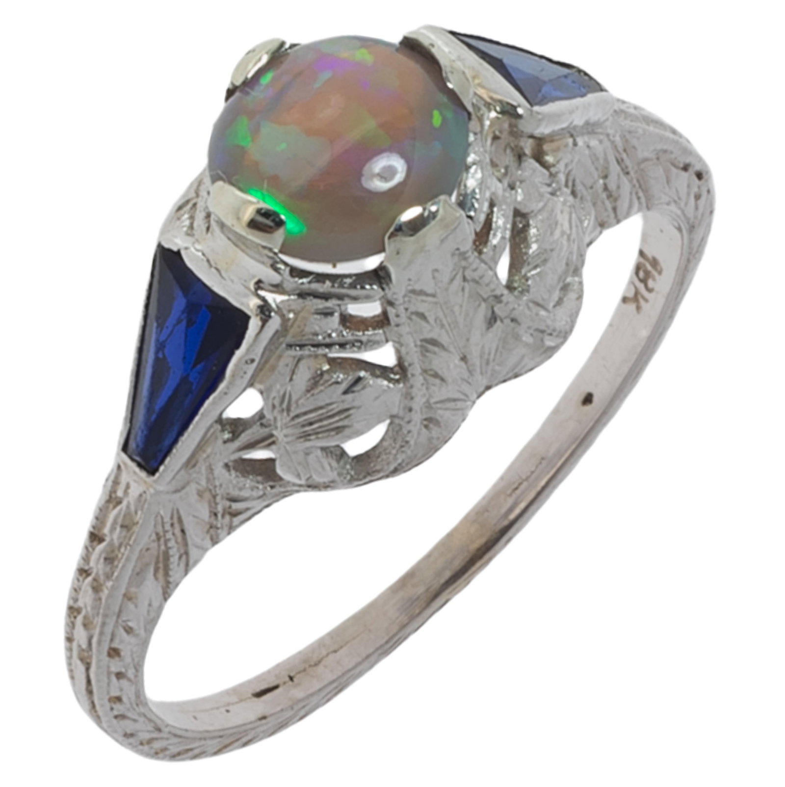 Art Deco Opal, Synthetic Sapphire, 18k White Gold Ring: Art Deco Opal, Synthetic Sapphire, 18k White Gold Ring Featuring one round opal cabochon flanked by two trapezoid-shape synthetic sapphires, set in an 18k white gold, filigree ring mounting, size 2 3/