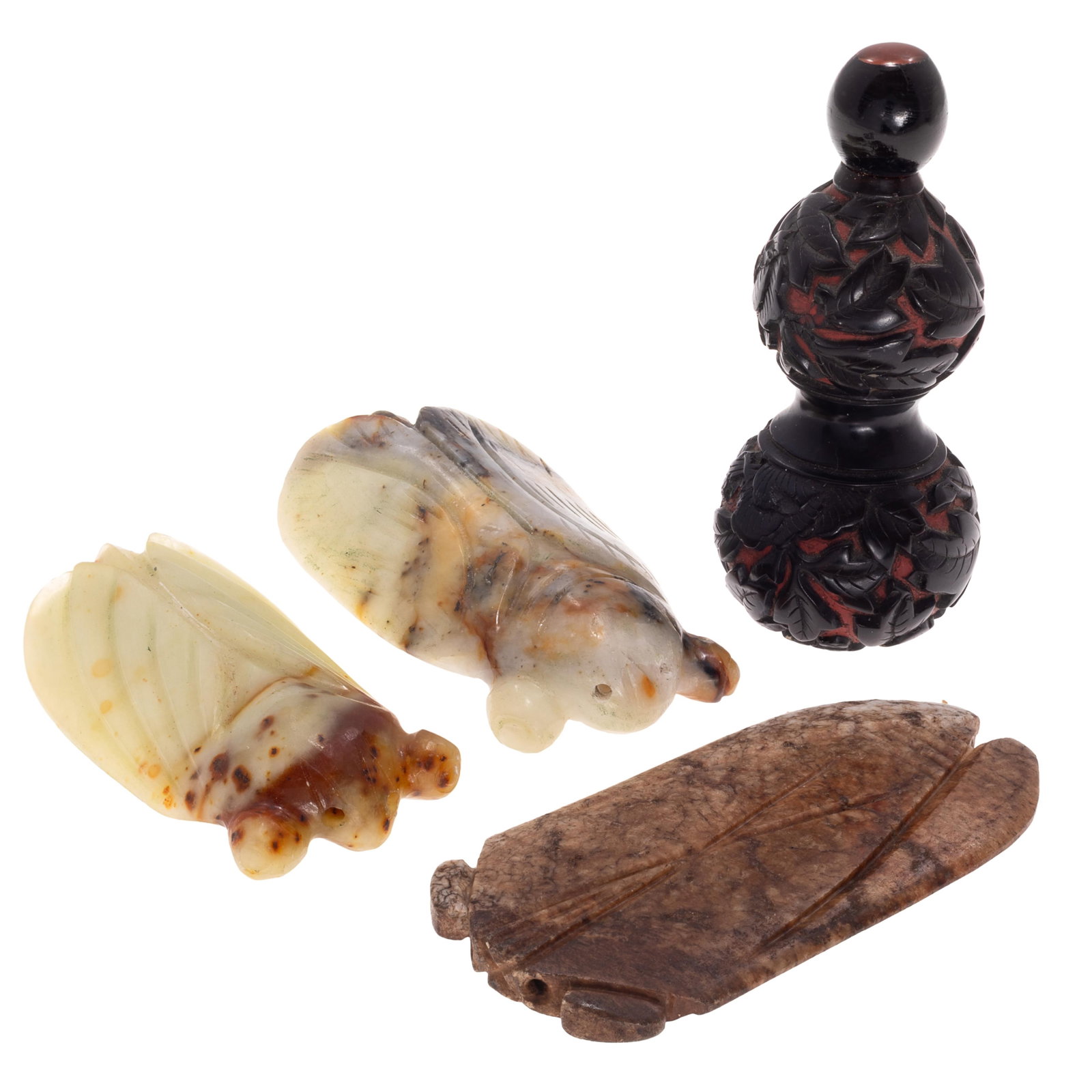 Chinese Jade Carvings and Snuff Bottle: Chinese Jade Carvings and Snuff Bottle Qing Dynasty to Republic Period, 19th-20th Century. Comprising three carved celadon and dark brown cicada pendants and a black and red double gourd form cinnabar