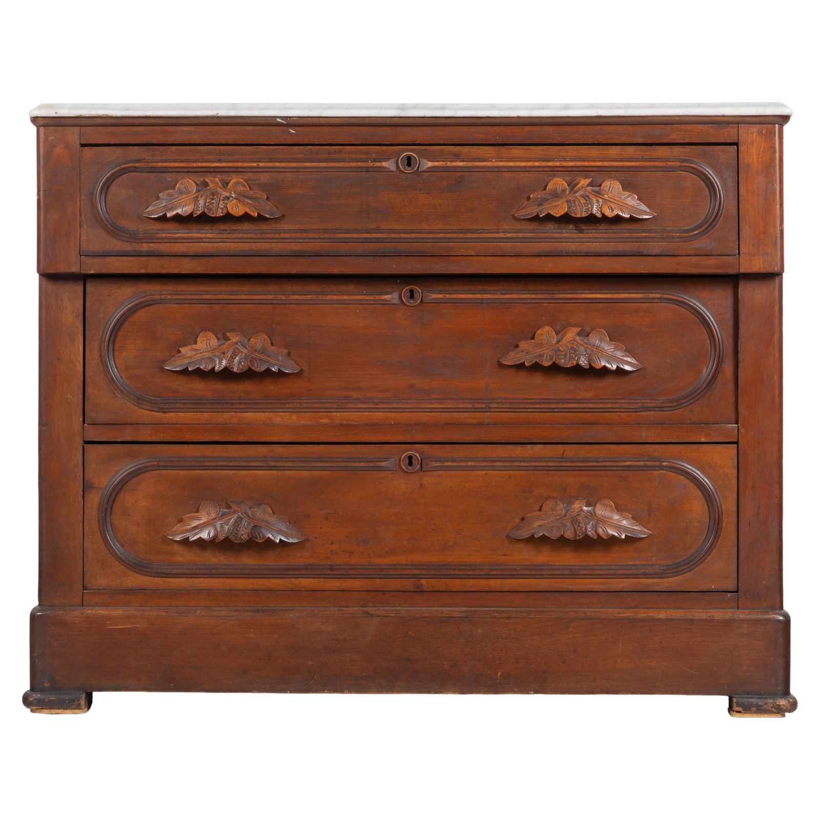 Victorian Walnut Chest of Drawers: Victorian Walnut Chest of Drawers Of stained hardwood with three drawers, the handles carved as oak leaf clusters, surmounted by a variegated marble top. 32in (82cm) h. 40in (102cm) l. 19in (48cm) d.