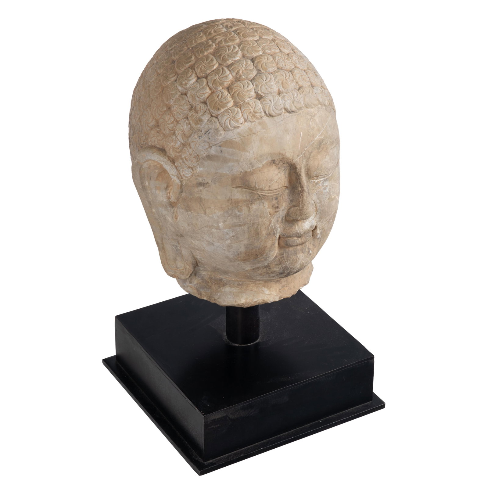 Stone Bust of Buddha: Stone Bust of Buddha The face with peaceful downcast expression under the snail shell hair arrangement. On a metal plinth. Bust 16in (41cm) Bust on plinth 24in (62cm) Base 11in (28cm) sq. Condition: