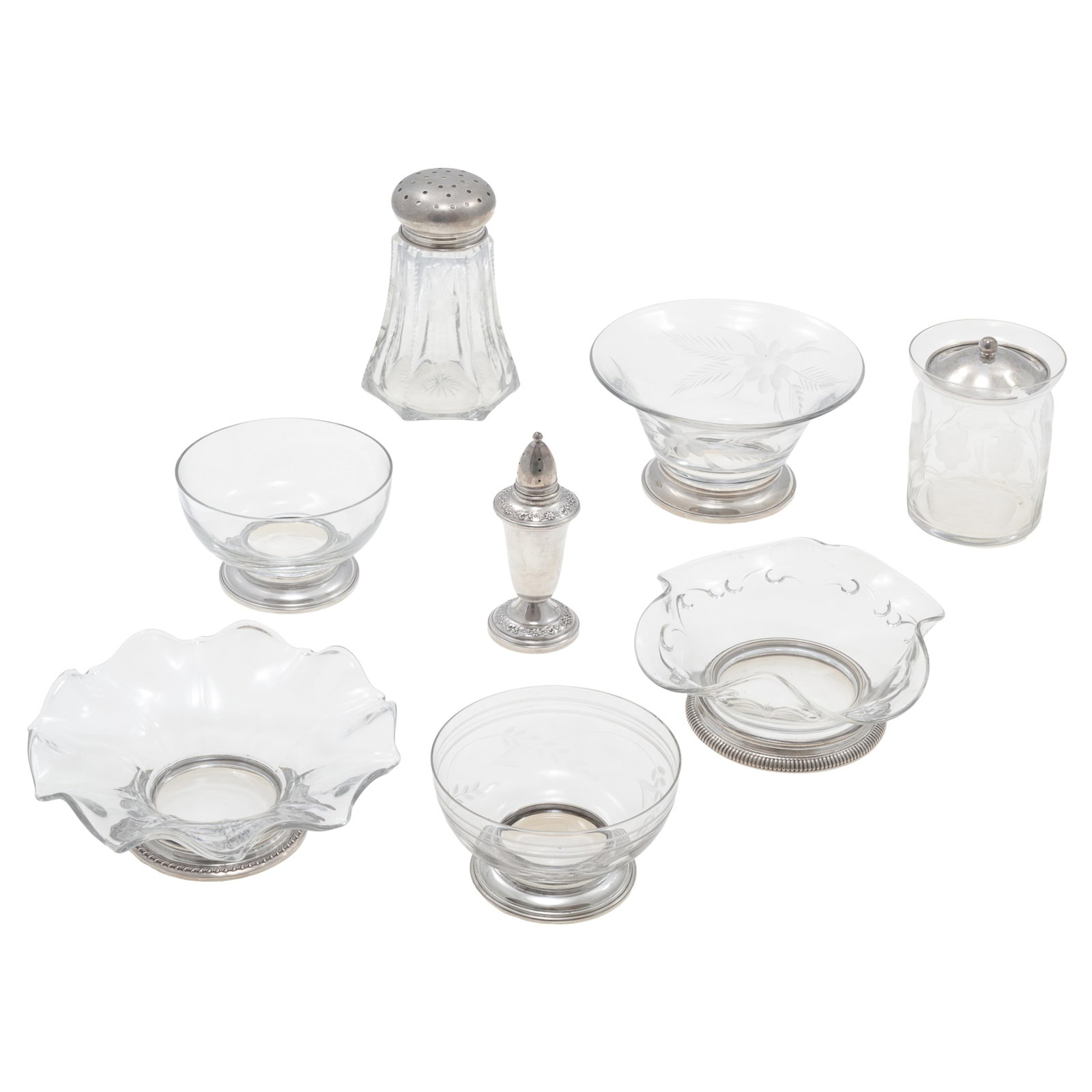 A Collection of Mid-Century Glass Serving Pieces: A Collection of Mid-Century Glass Serving Pieces All of clear glass, including two small bowls with sterling bases,4 1/2in d, two ruffled rim bowls, one with a sterling base, 6in d. a floral incised b