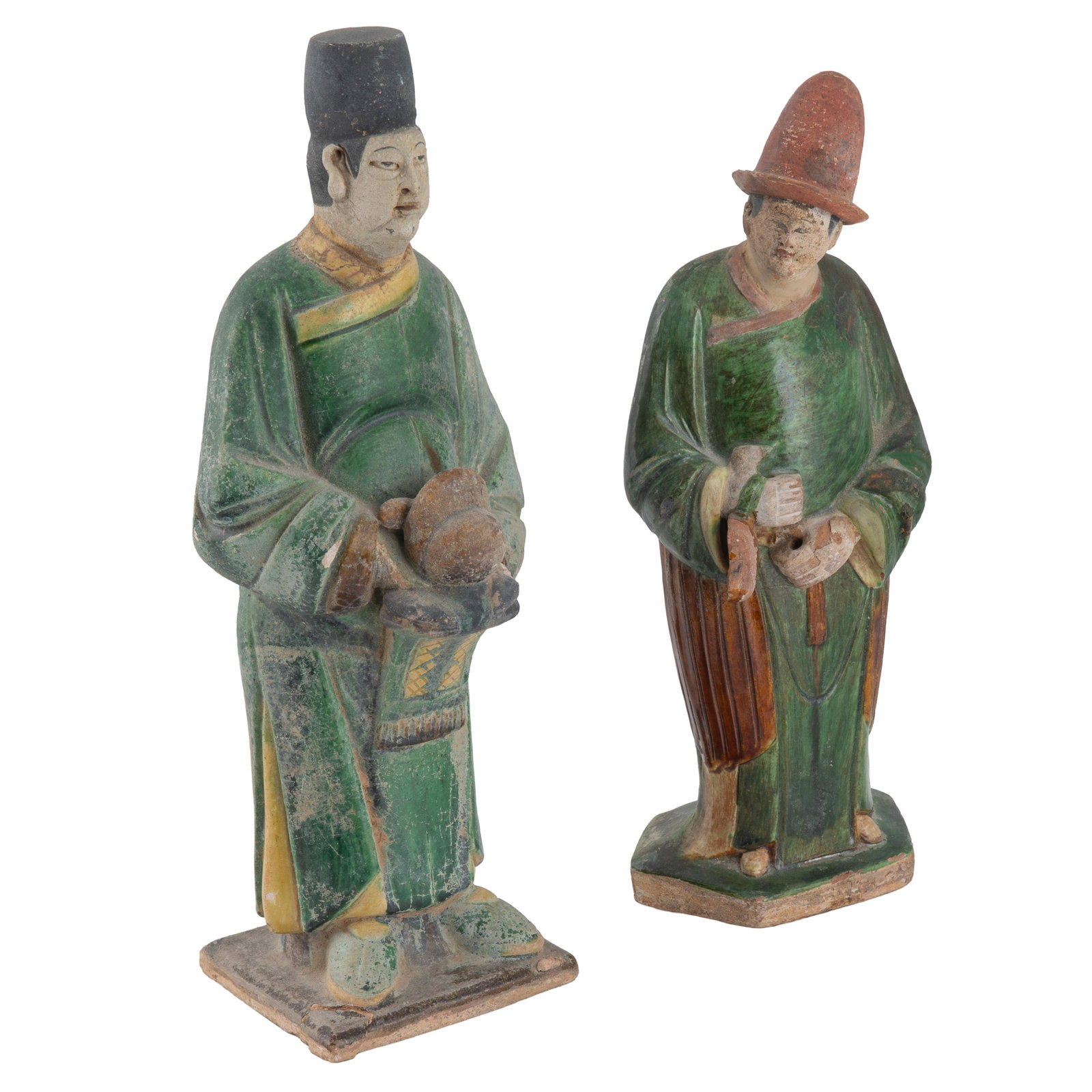 Two Ming Style Attendant Figures: Two Ming Style Attendant Figures Comprising two standing attendants, each dressed in long robes with green glaze and ochre highlights, on integral plinths, one holding a covered vessel, another
