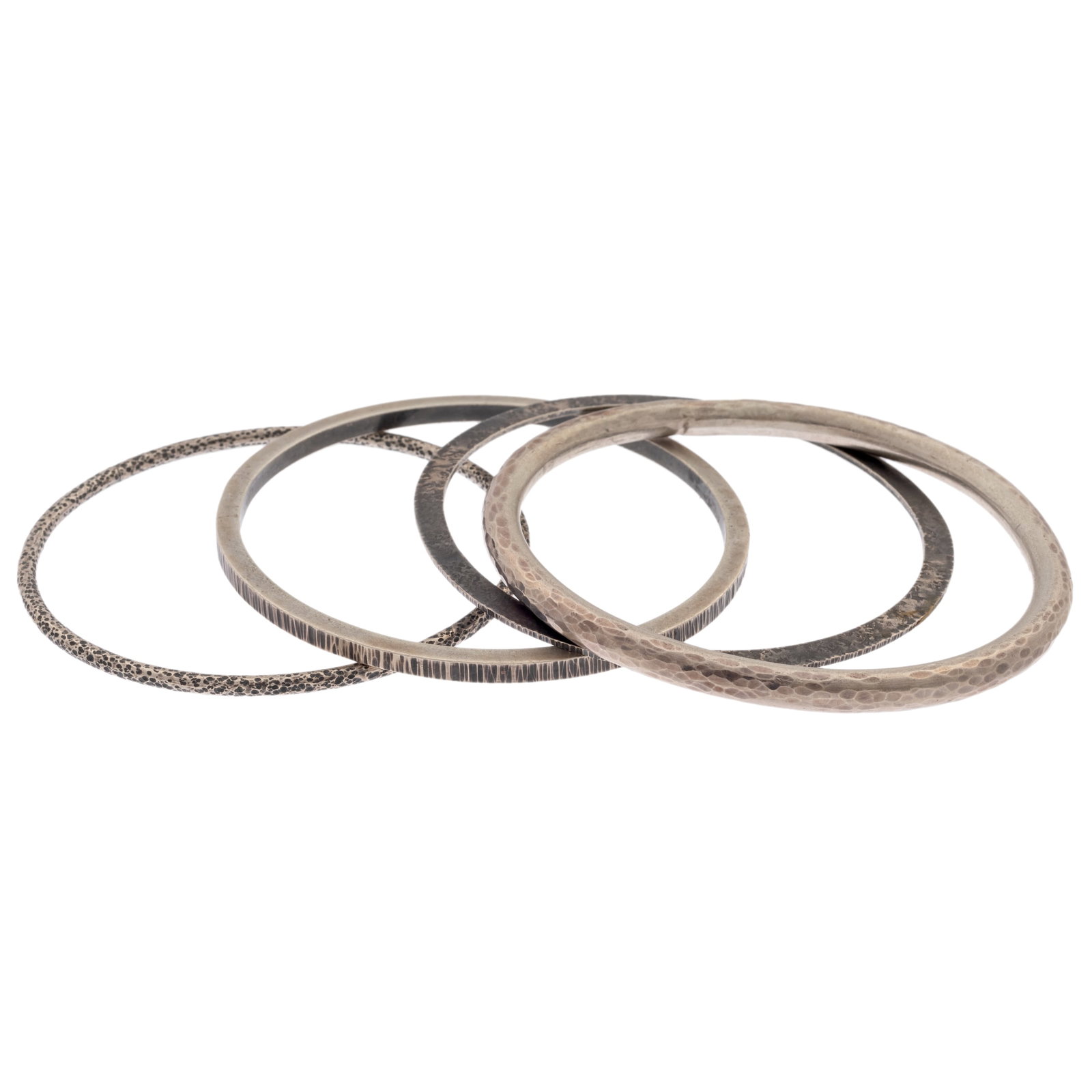 Collection of Four Sterling Silver Bangle Bracelets, Owen McInerney: Collection of Four Sterling Silver Bangle Bracelets, Owen McInerney All sterling silver, including one flat, patinated bangle measuring approximately 1.2 mm (0.05 in) in width, inner circumference 8 i