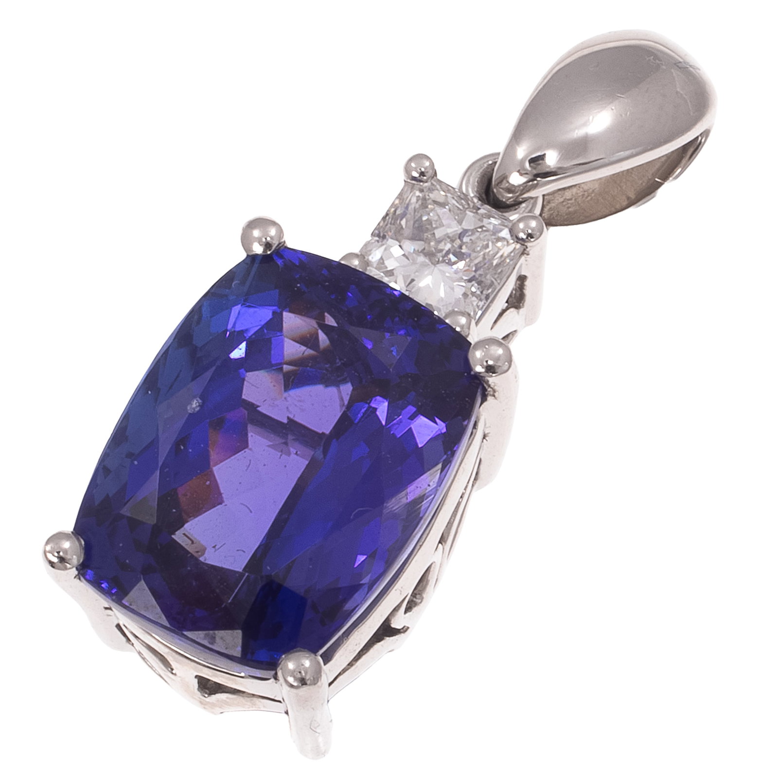 Tanzanite, Diamond, Platinum Pendant, Rhapsody: Tanzanite, Diamond, Platinum Pendant, Rhapsody Featuring one cushion-shaped tanzanite weighing approximately 6.55 cts., topped by one princess-cut diamond weighing approximately 0.46 ct., set in a